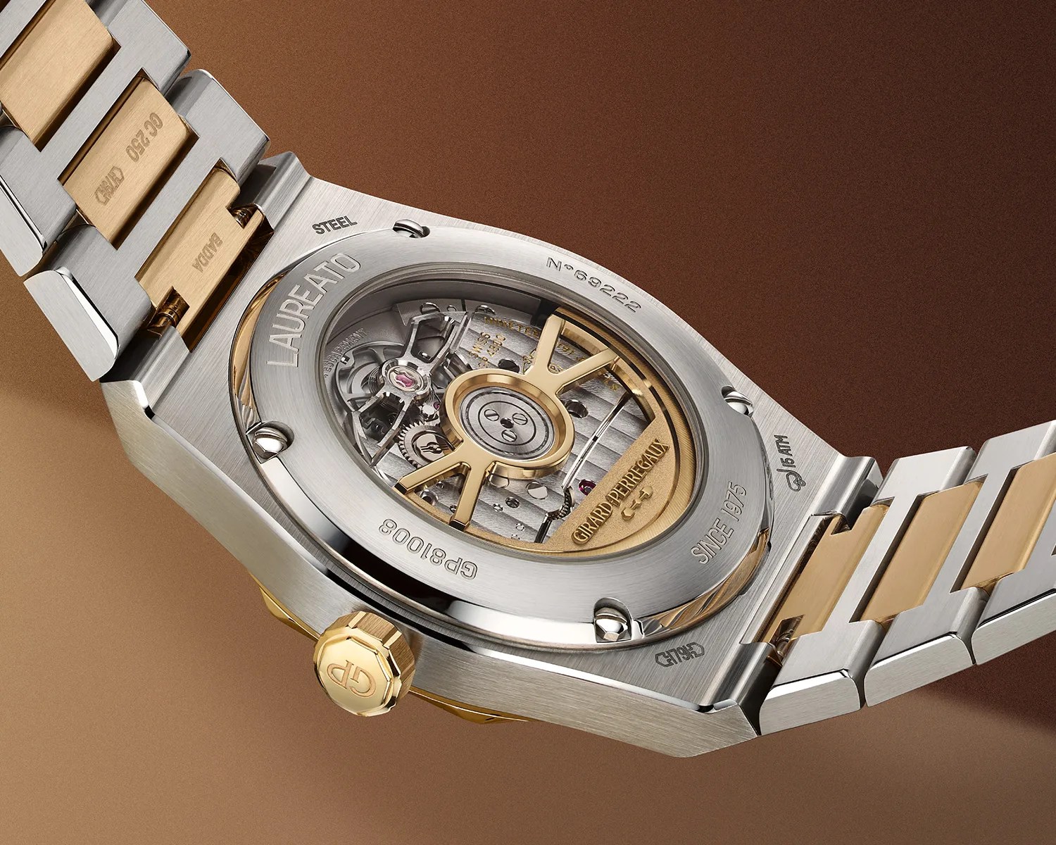Back of a two-tone stainless steel and gold Girard-Perregaux Laureato watch showing the automatic movement through a transparent case back.