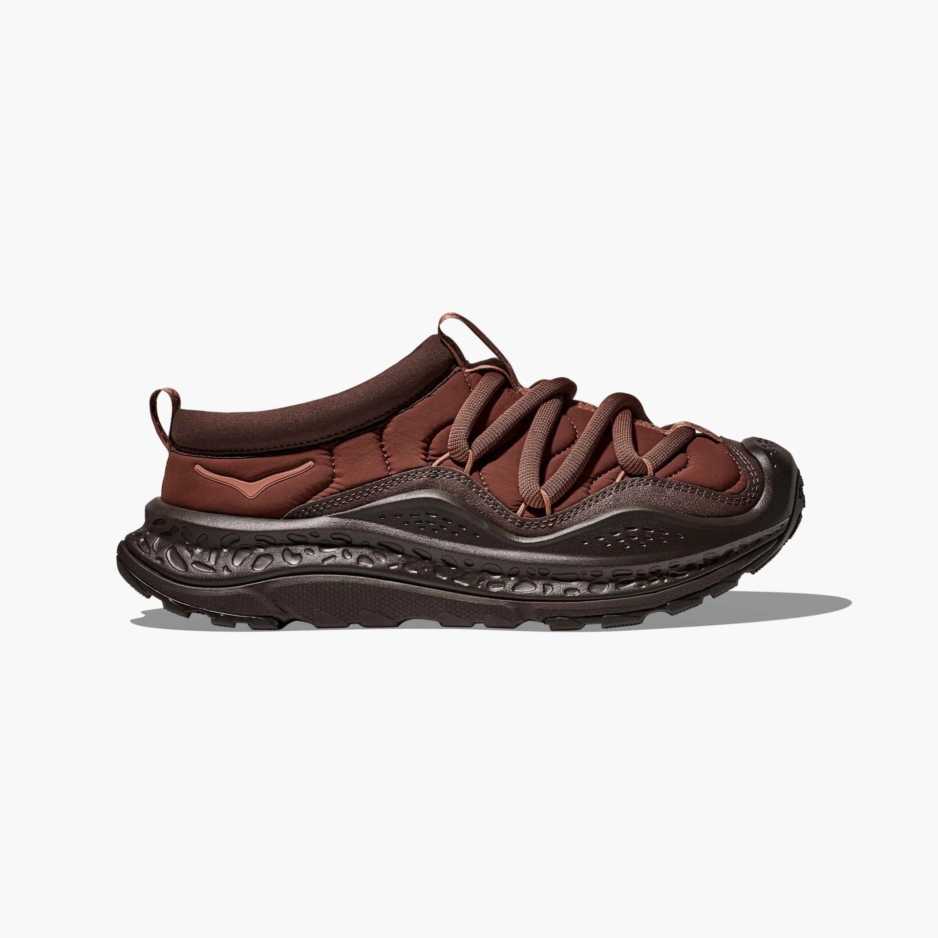 Brown and dark brown athletic sneaker with thick textured sole and looped laces on a white background.