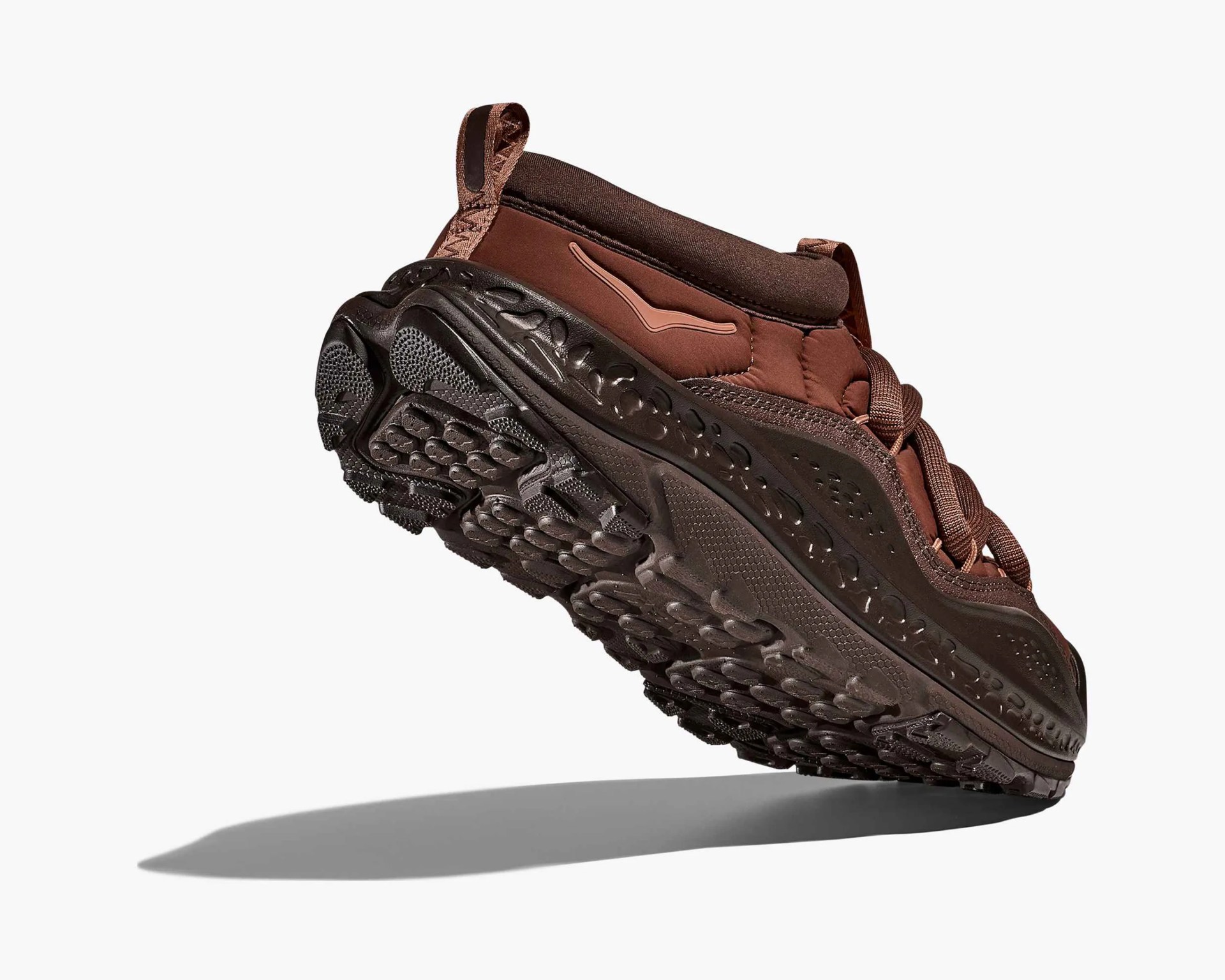 Brown sneaker with textured black sole and pull tabs on heel and tongue.