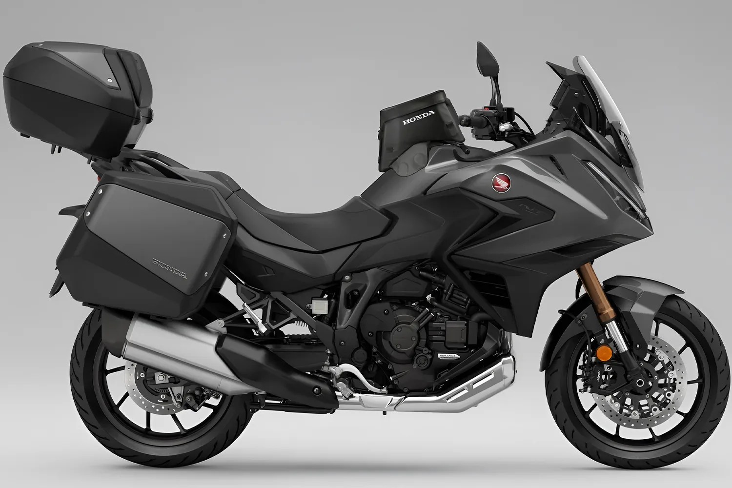 Gray Honda touring motorcycle with side and rear storage boxes and a small tank bag.