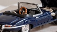 Blue convertible toy car with brown steering wheel and detailed interior.