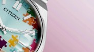 Close-up of a Citizen watch with a light blue dial featuring colorful puzzle piece designs and silver hour markers.