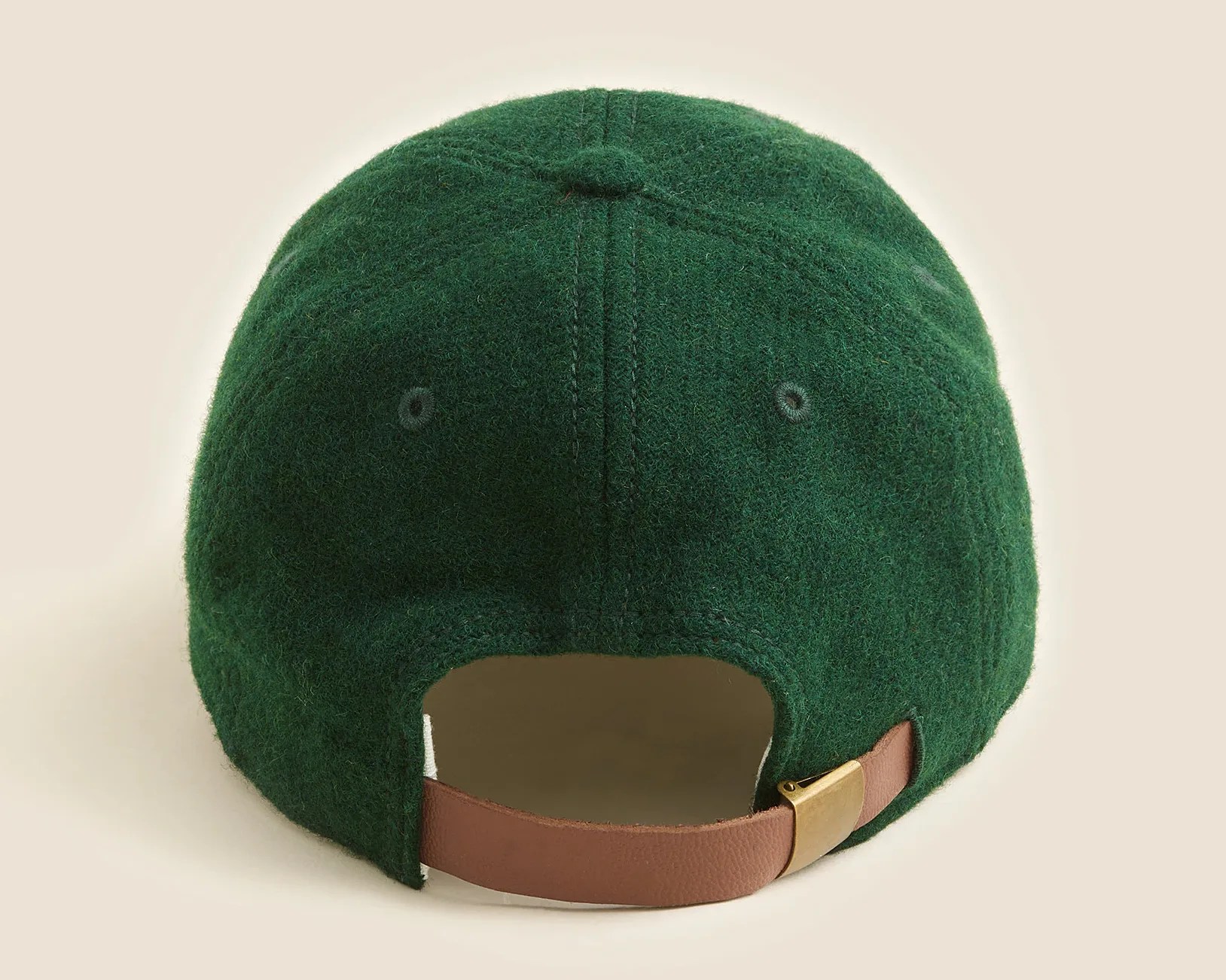 Dark green wool baseball cap with brown adjustable leather strap and brass buckle shown from the back.