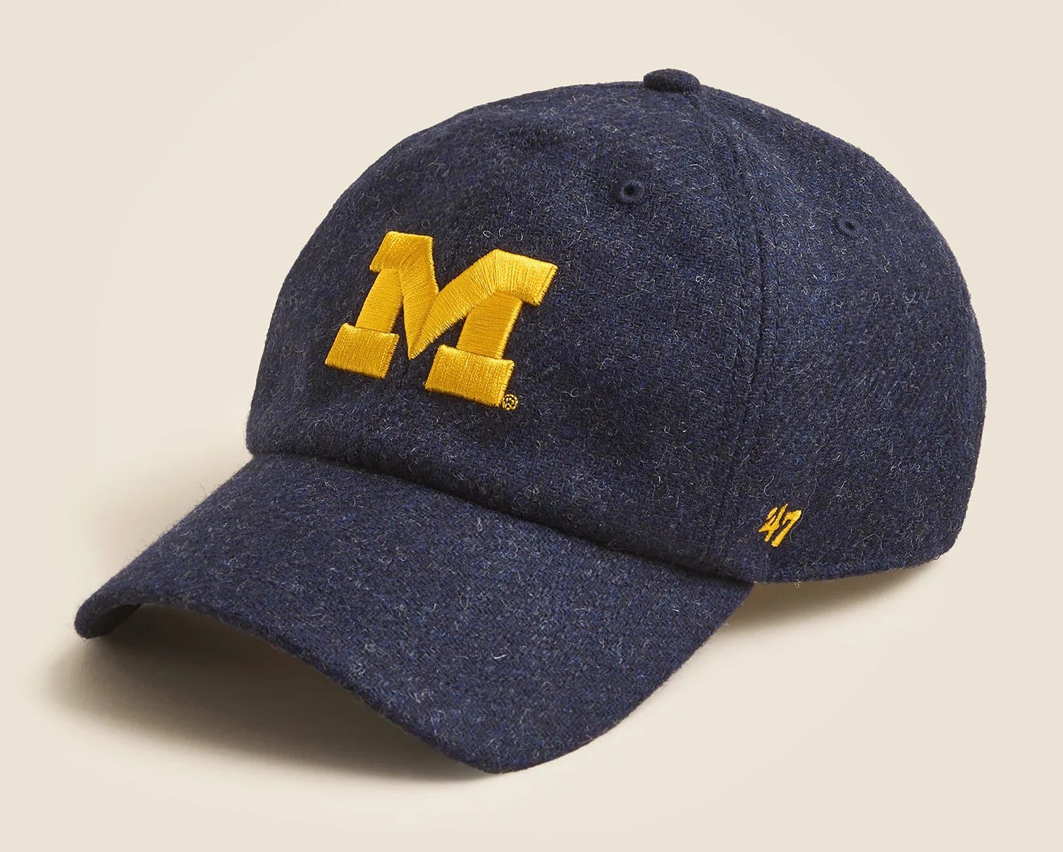 Navy blue wool baseball cap with a large yellow "M" embroidered on the front and a small yellow "47" logo on the side.