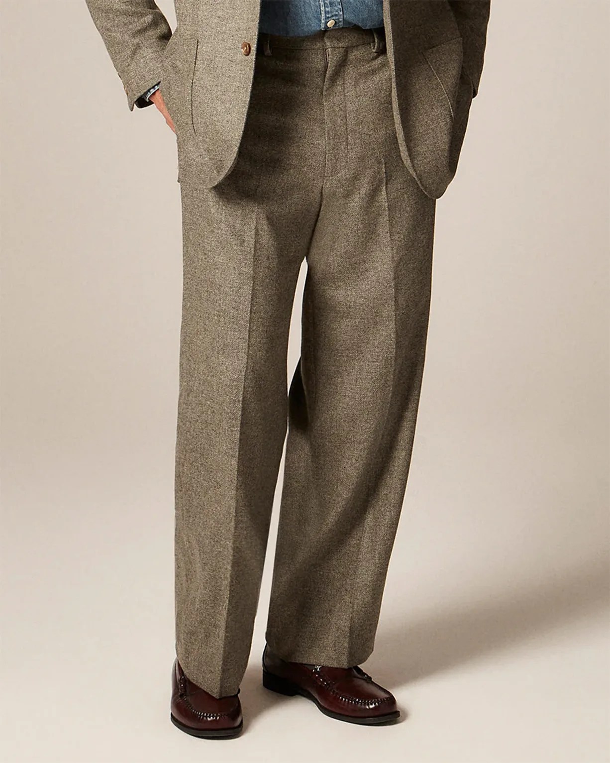Brown tweed wide-leg trousers paired with matching blazer and dark brown leather loafers.