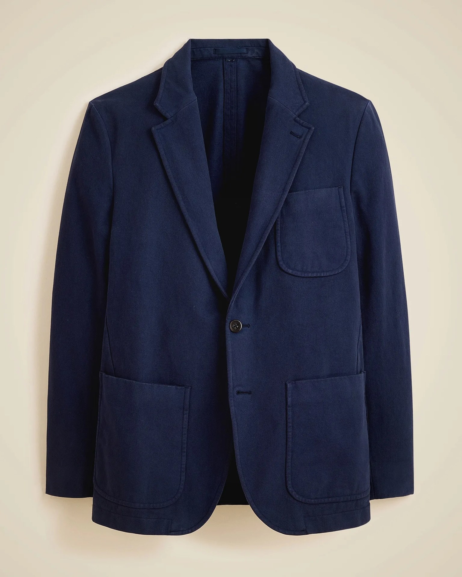 Navy blue single-button blazer with notch lapels and three patch pockets.