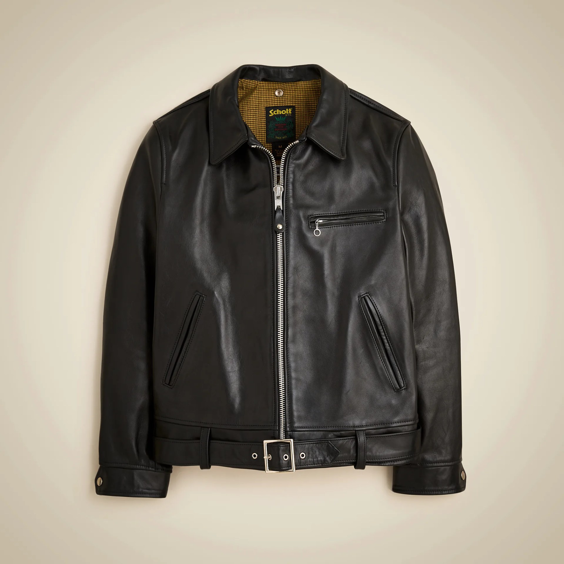 Black leather jacket with silver zipper, chest pocket, side pockets, and belt at the waist.
