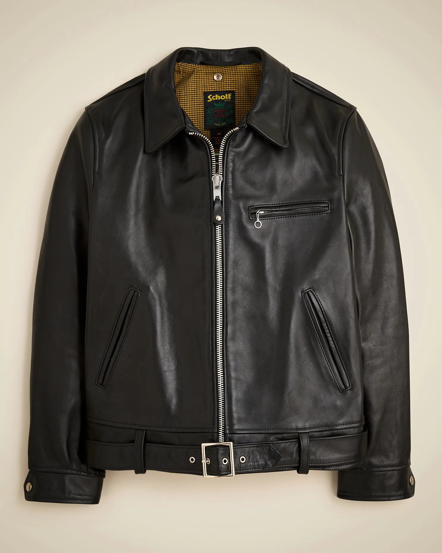 Black leather jacket with silver zipper, chest pocket, side pockets, and belt at the waist.