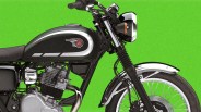 Black and silver classic motorcycle fuel tank and front wheel against a green background.