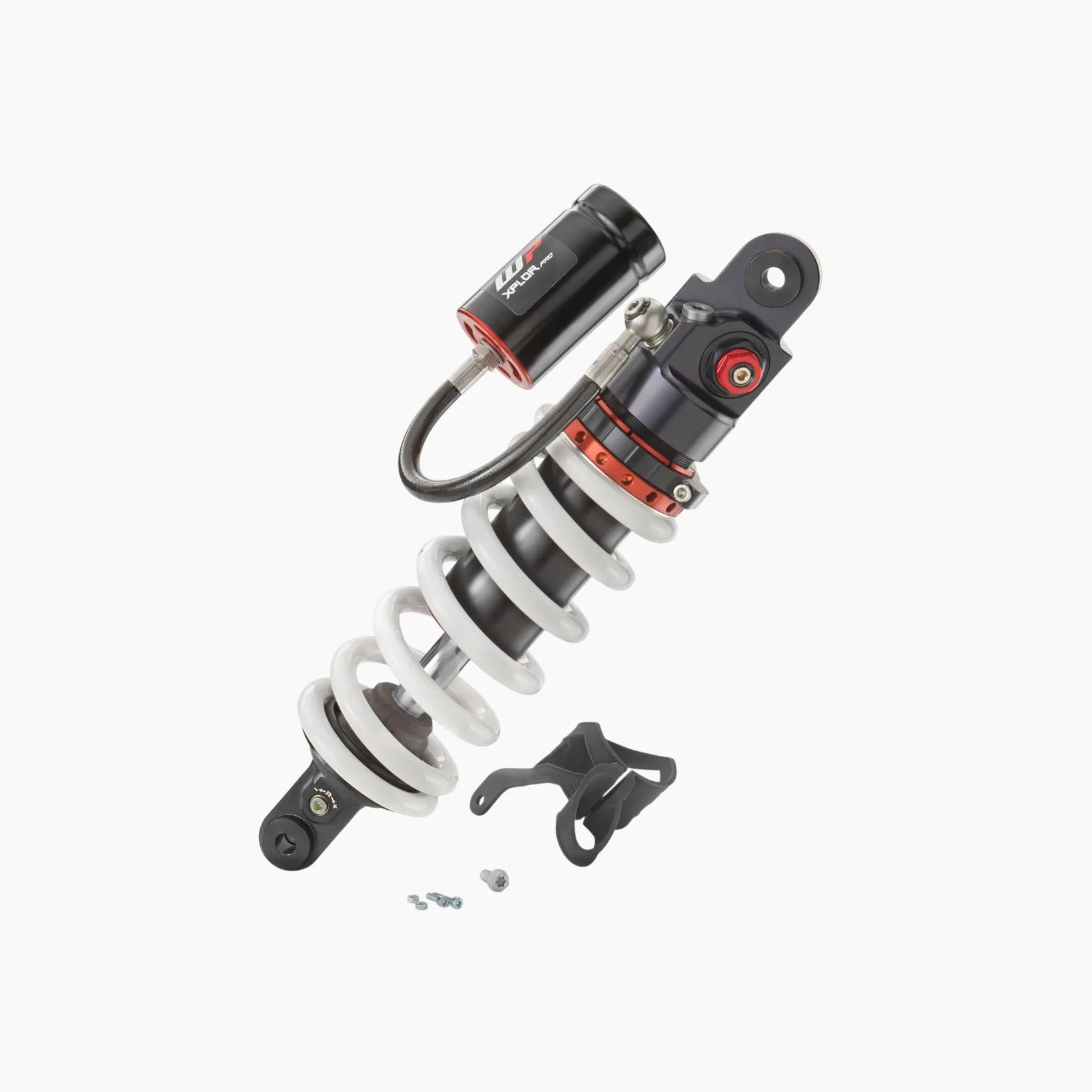Black and white coil shock absorber with red accents and attached reservoir, shown with mounting hardware.