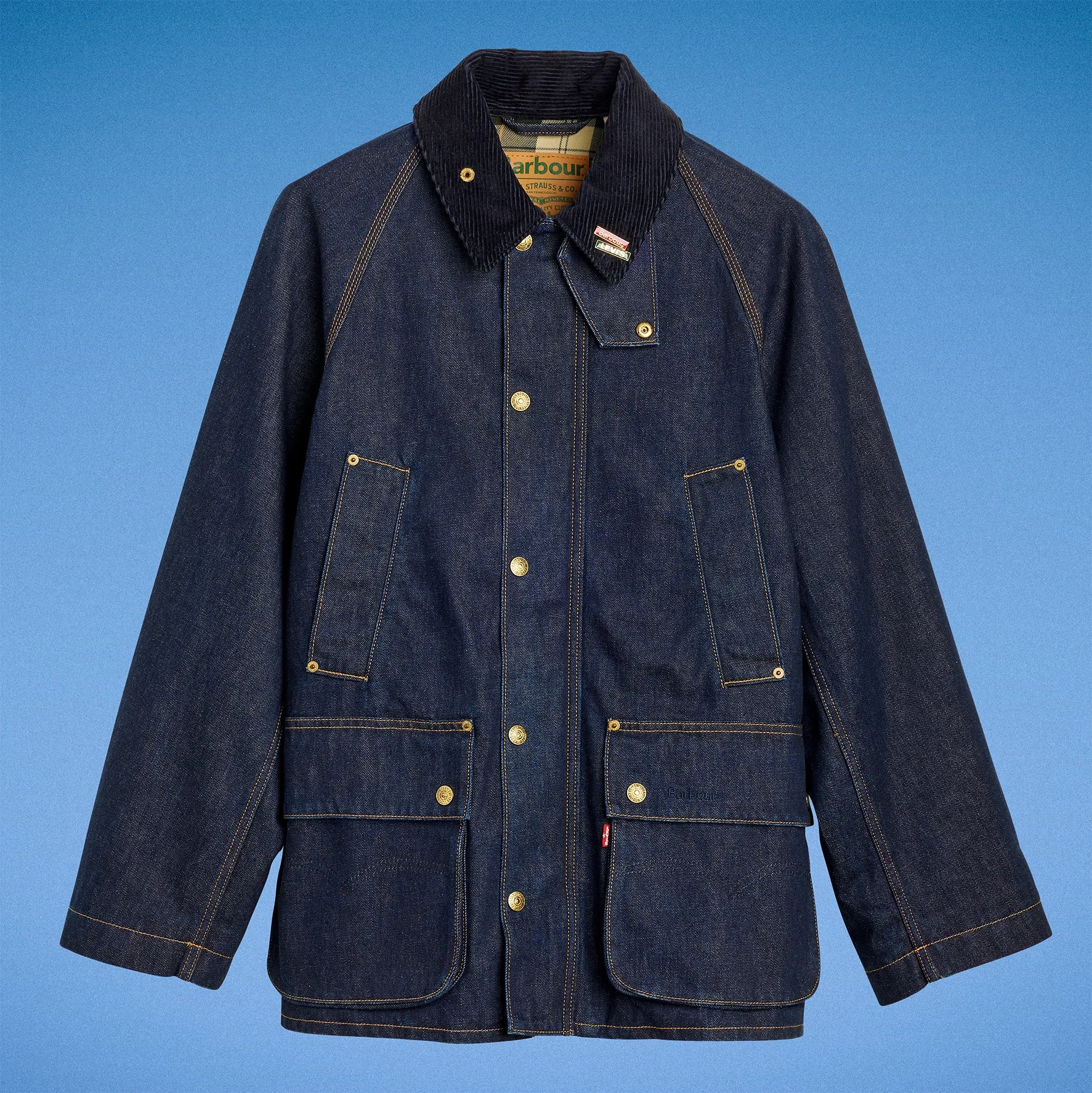 Dark blue denim jacket with corduroy collar and multiple front pockets against a blue background.