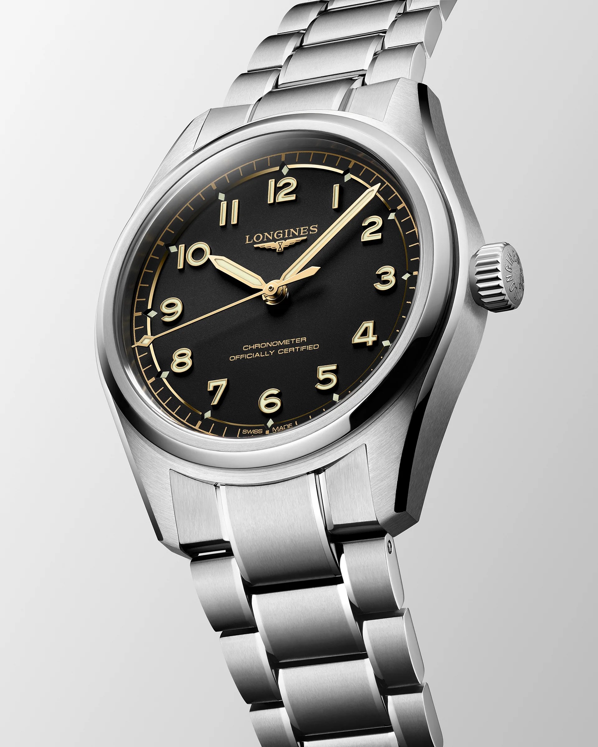 Silver stainless steel Longines wristwatch with black dial and gold Arabic numerals on a metal bracelet.