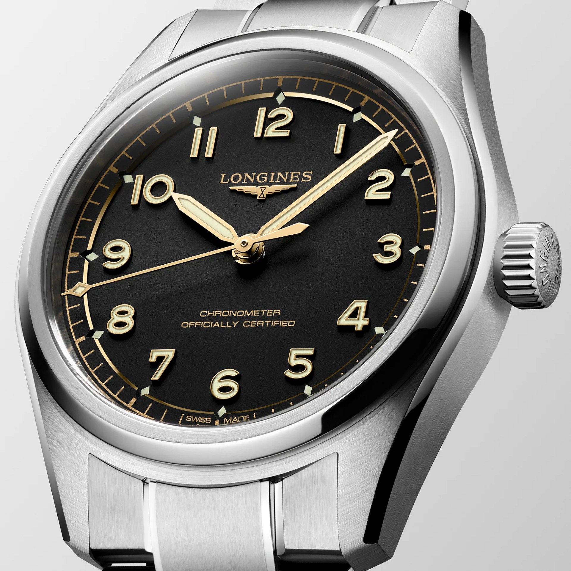 Close-up of a Longines stainless steel wristwatch with a black dial and gold-tone numerals and hands.