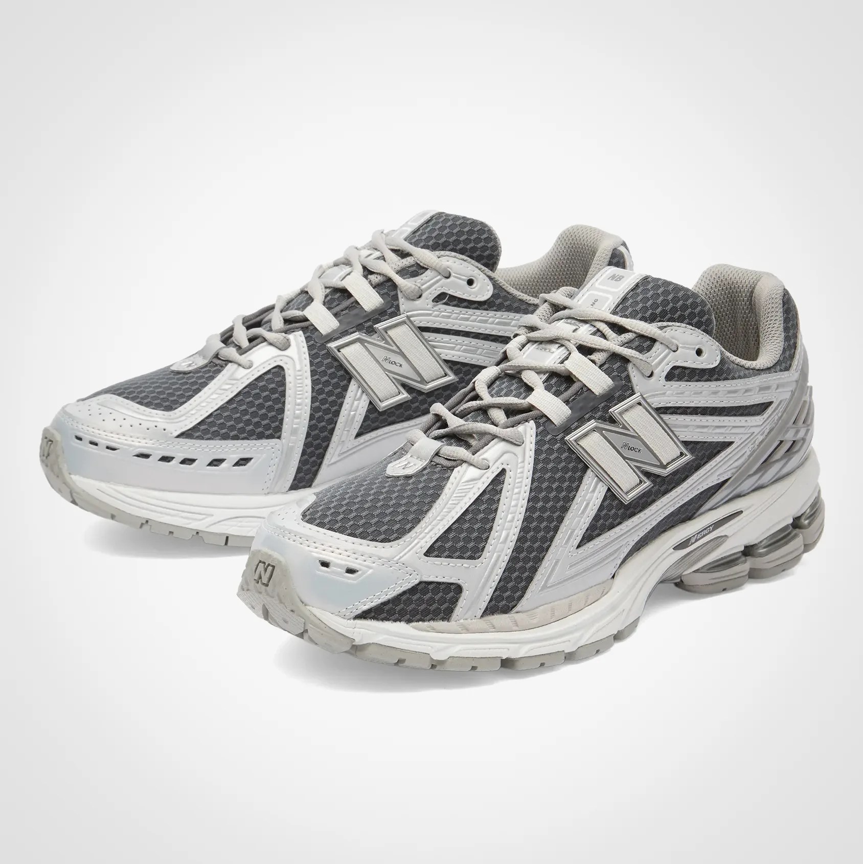 Pair of gray and white New Balance running shoes with mesh and synthetic overlays on a white background.