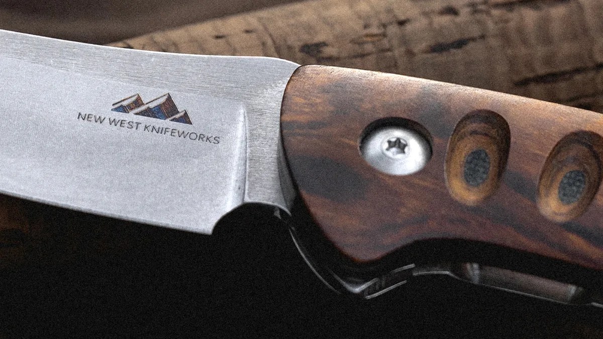 Knife blade with "New West Knifeworks" logo and wooden handle with metal rivets.