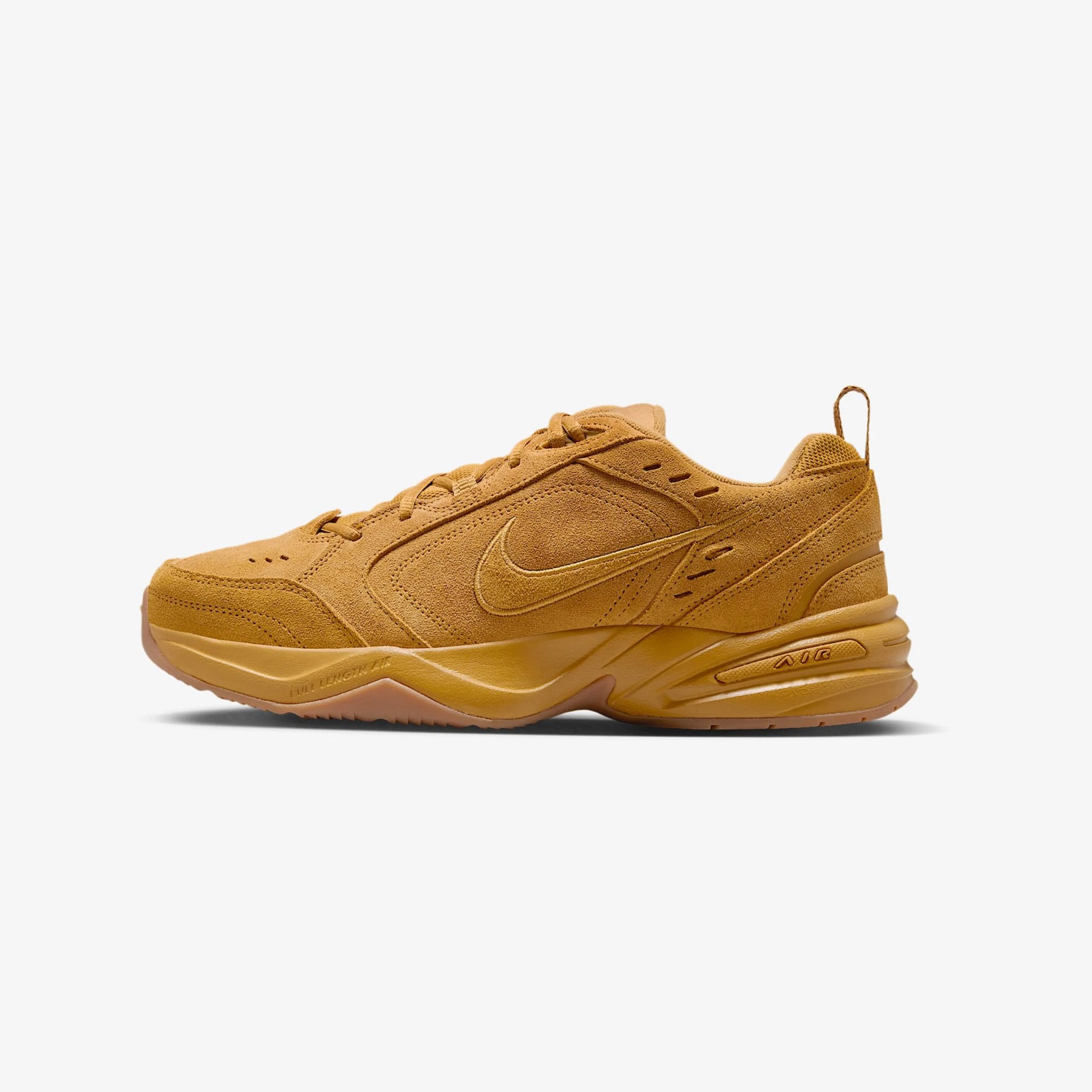 Tan suede Nike Air Monarch IV sneaker with tonal swoosh logo and thick sole.