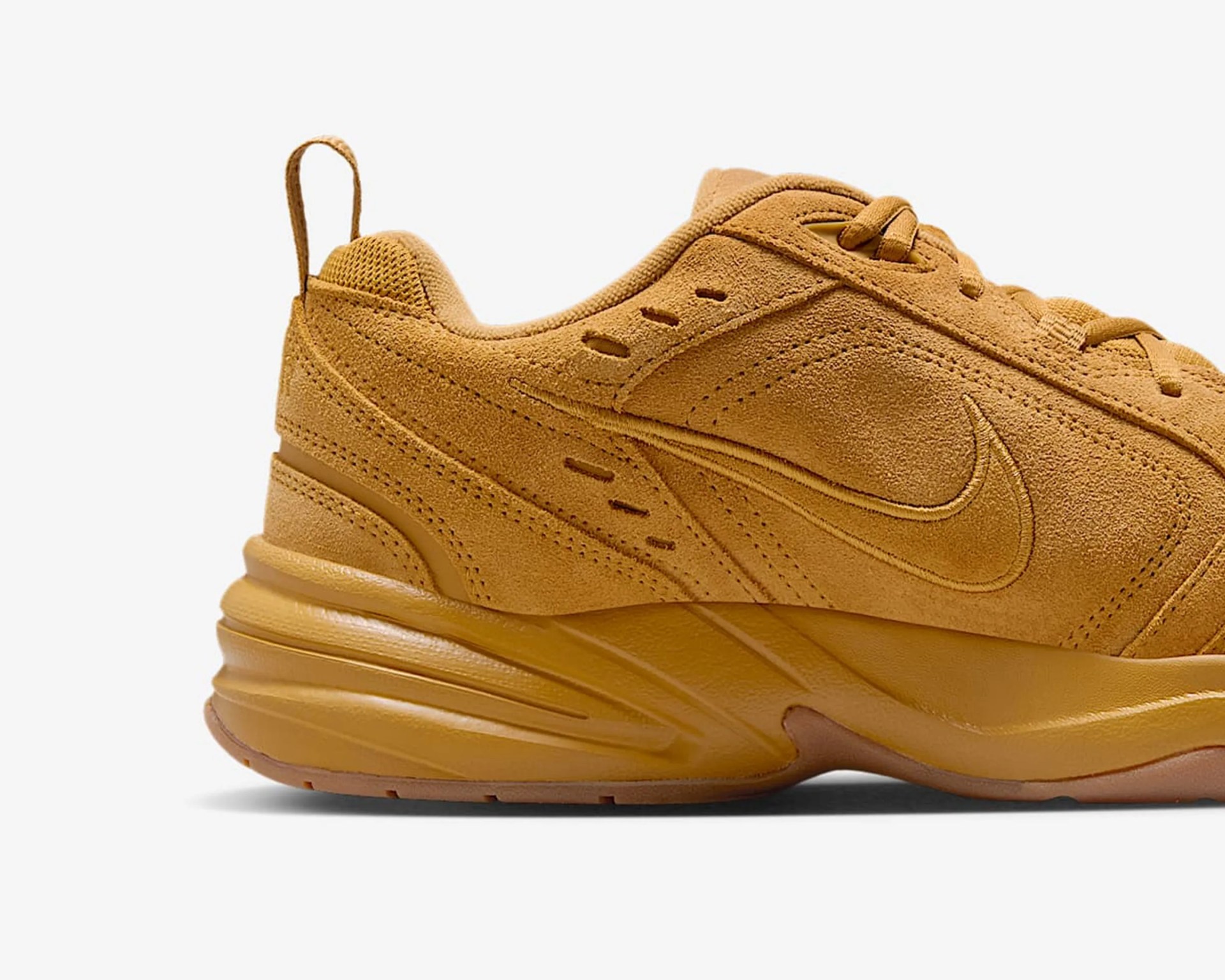 Tan suede Nike sneaker with tonal stitching and a thick rubber sole.
