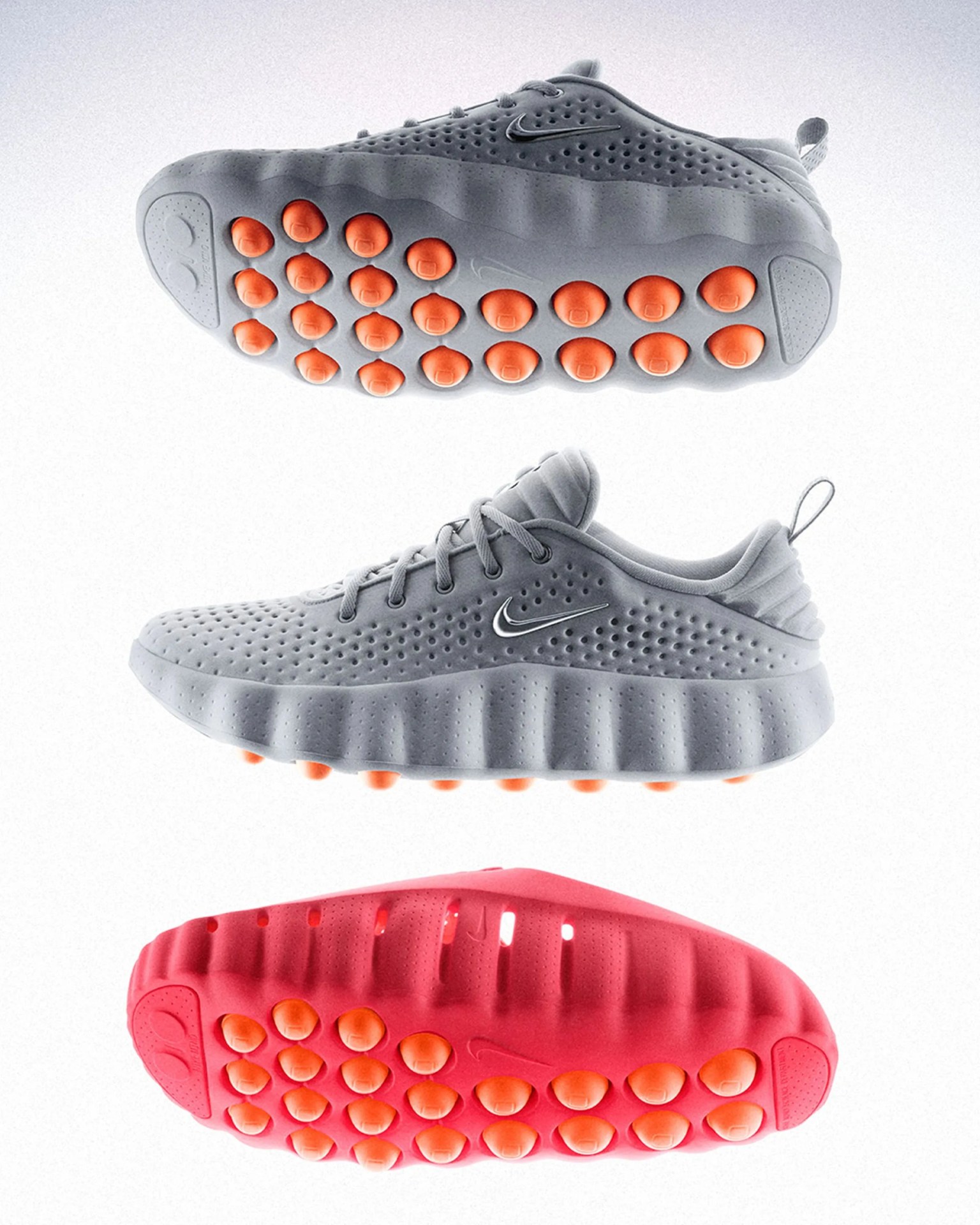 Gray Nike sneaker with perforated upper and orange circular traction pods on sole, shown from side and bottom views.