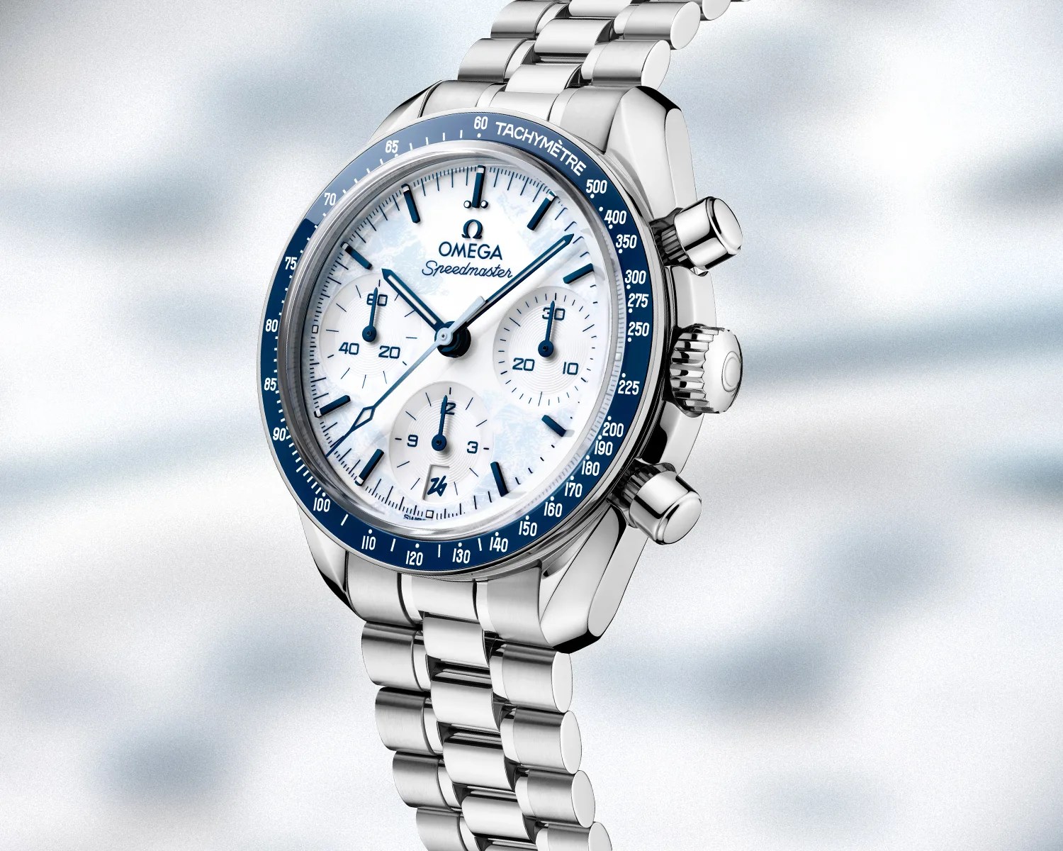 Silver Omega Speedmaster chronograph watch with white dial and blue tachymeter bezel on a metal bracelet.
