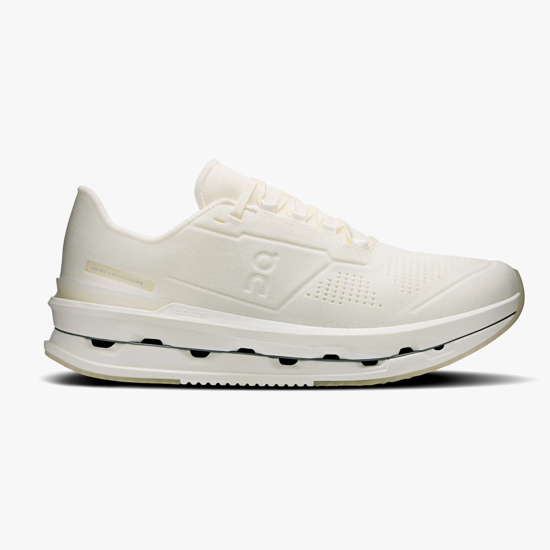 Off-white low-top running shoe with textured fabric upper and thick cushioned sole.