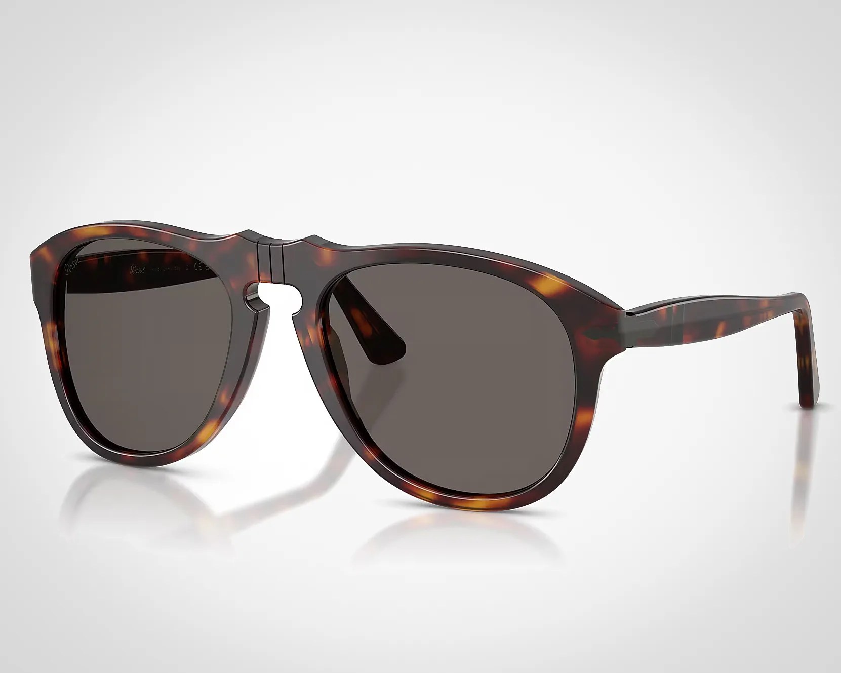 Tortoiseshell acetate sunglasses with dark lenses and a keyhole bridge on a white background.