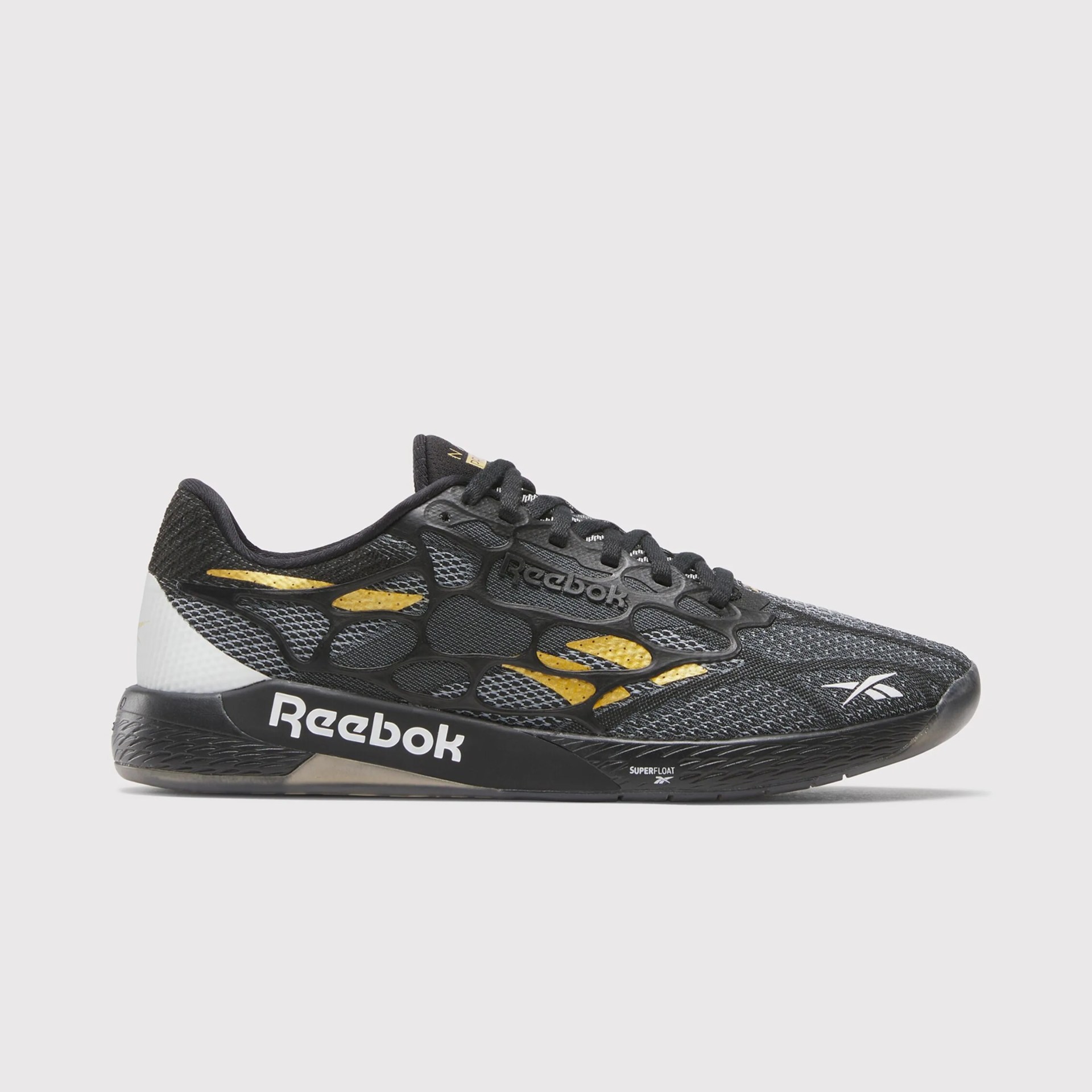 Black and gold Reebok running shoe with mesh upper and white Reebok logo on the sole and toe.