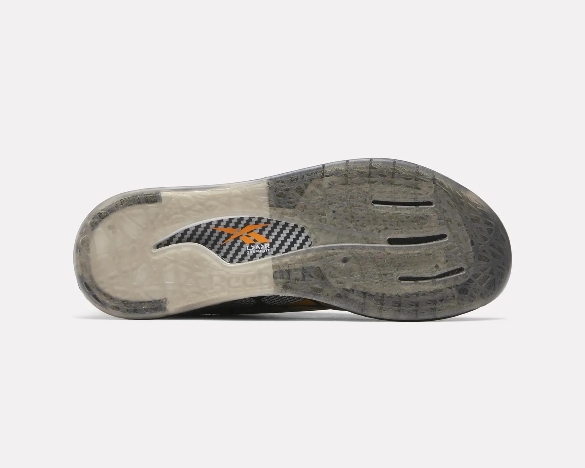 Transparent rubber outsole with black and orange Reebok logo and carbon fiber detail.