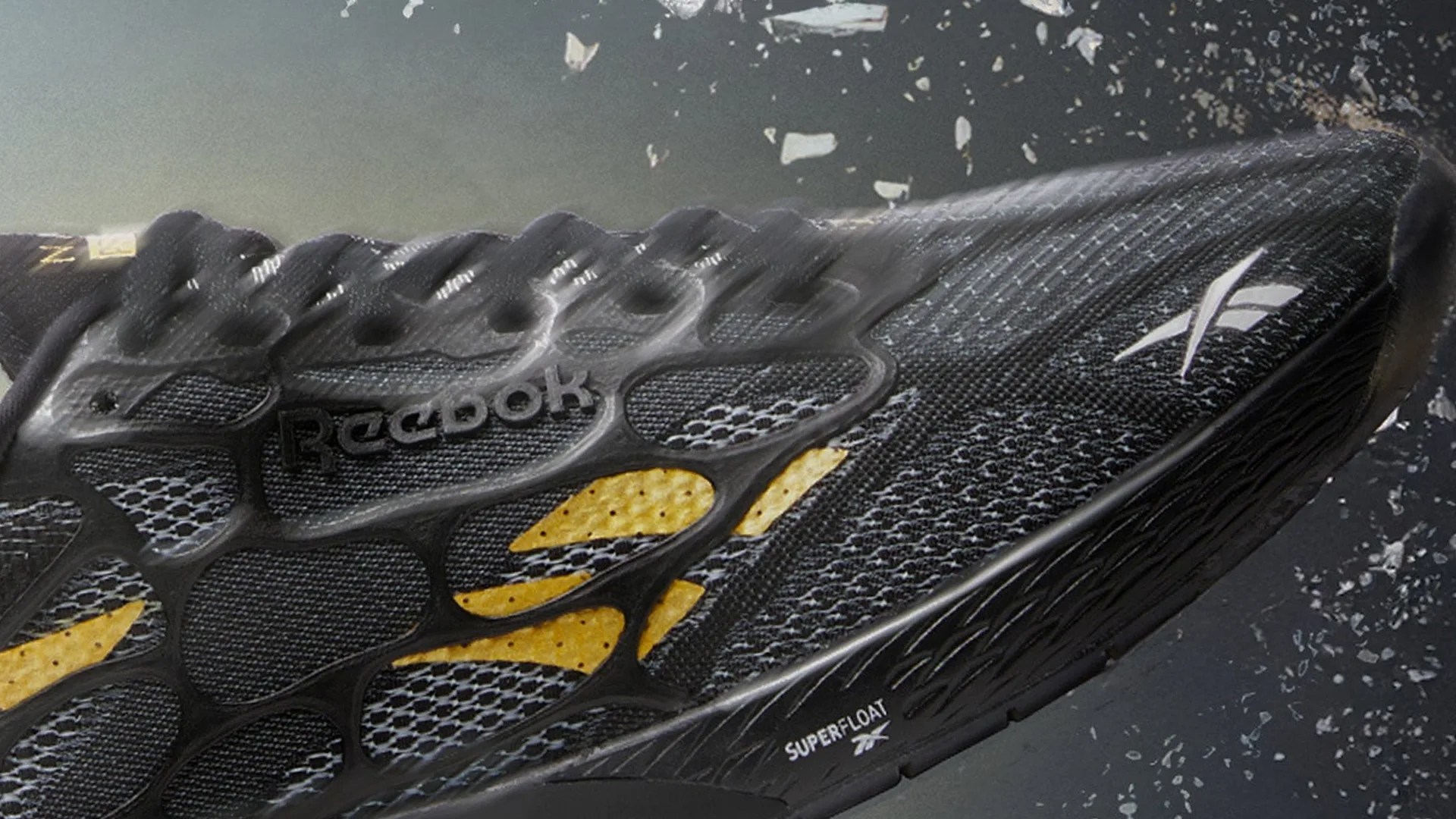 Close-up of a black Reebok running shoe with yellow accents and "SUPERFLOAT" branding on the sole.