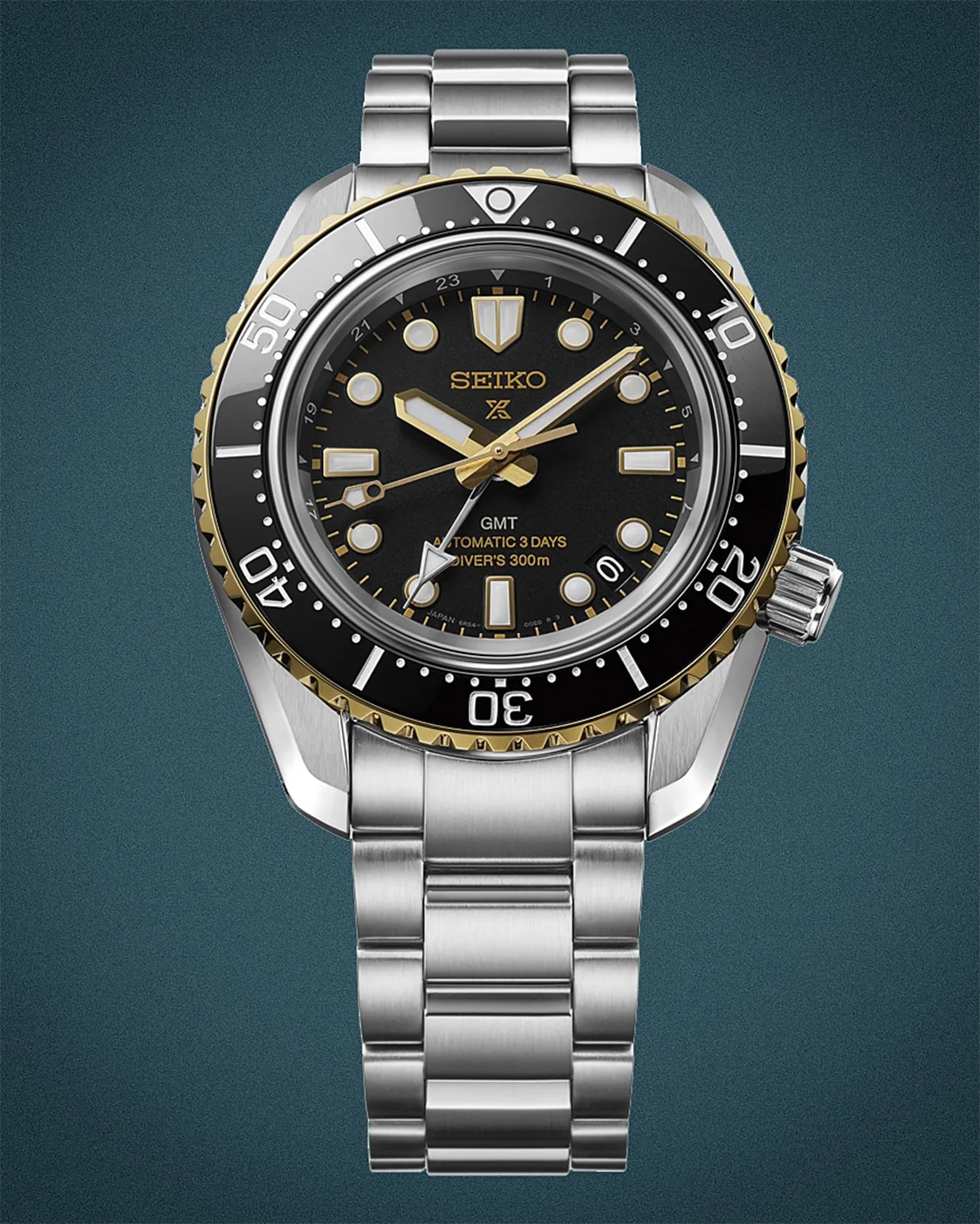 Seiko stainless steel diver's watch with black and gold bezel and black dial showing GMT and 300m water resistance.