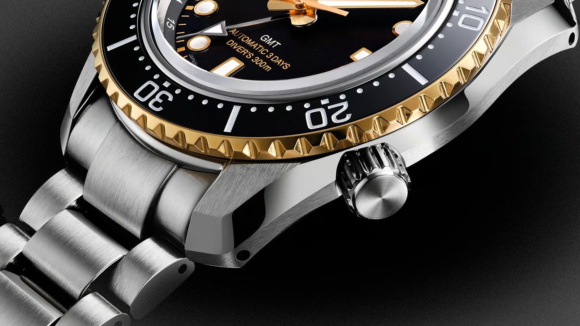 Close-up of a stainless steel diver's watch with a black and gold bezel and a black dial showing "GMT AUTOMATIC 3 DAYS DIVER'S 300m.
