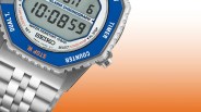 Digital Seiko wristwatch with blue bezel, silver metal band, and multiple function labels on the face.