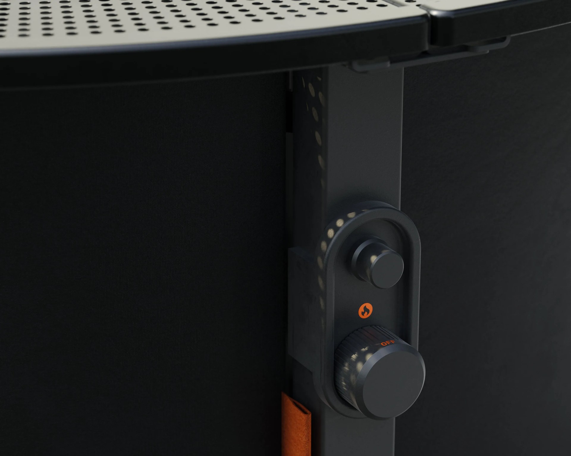 Close-up of a black metal control knob with an orange flame icon and "OFF" label on a perforated metal surface.