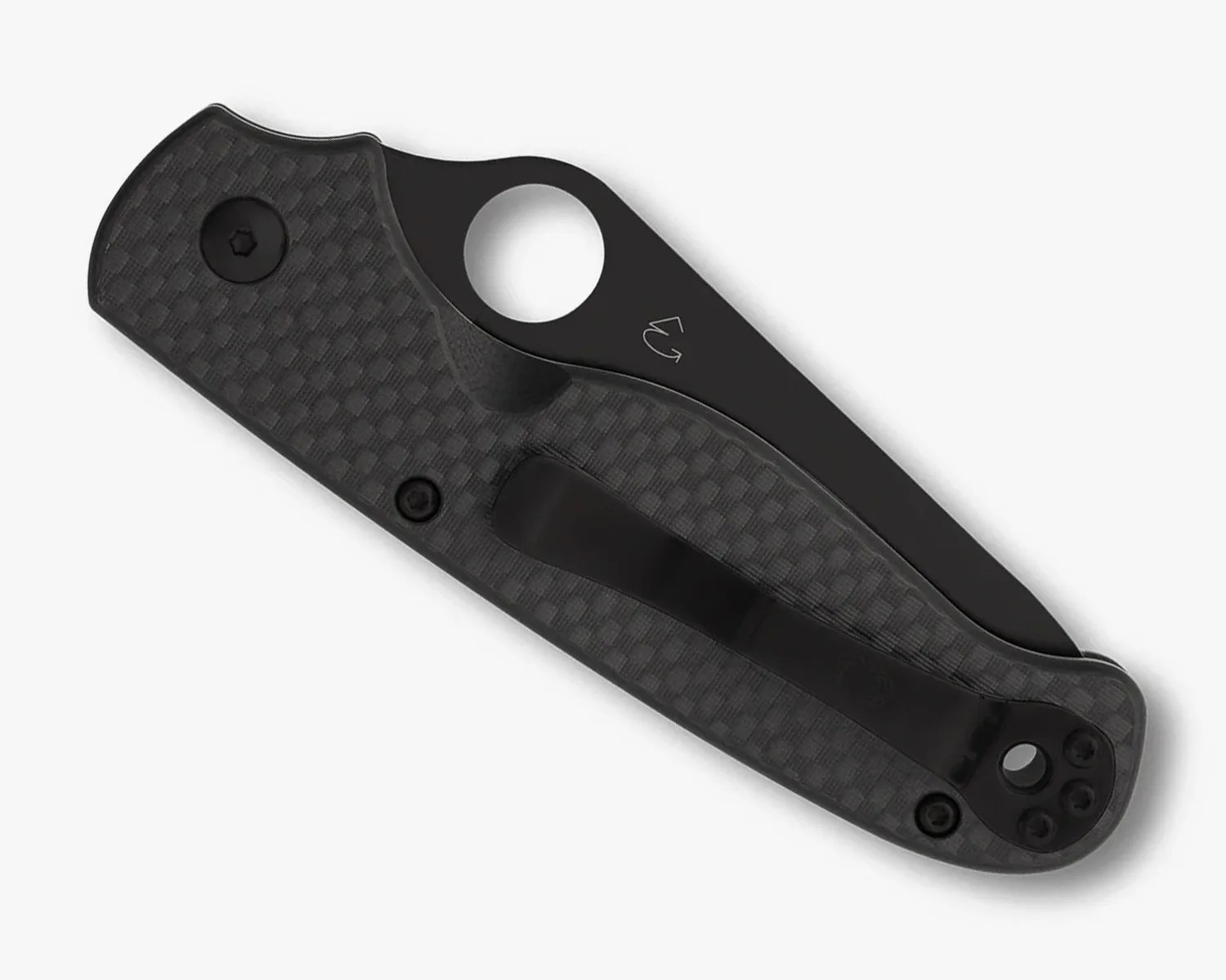 Folded black pocket knife with textured handle and circular thumb hole on a white background.