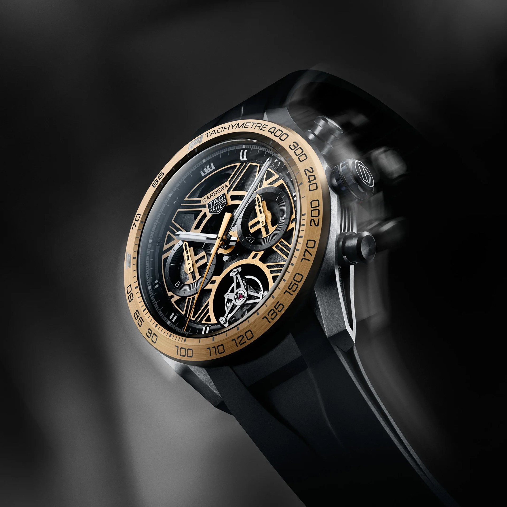 TAG Heuer Carrera watch with black and gold skeleton dial, tachymeter bezel, and black strap.