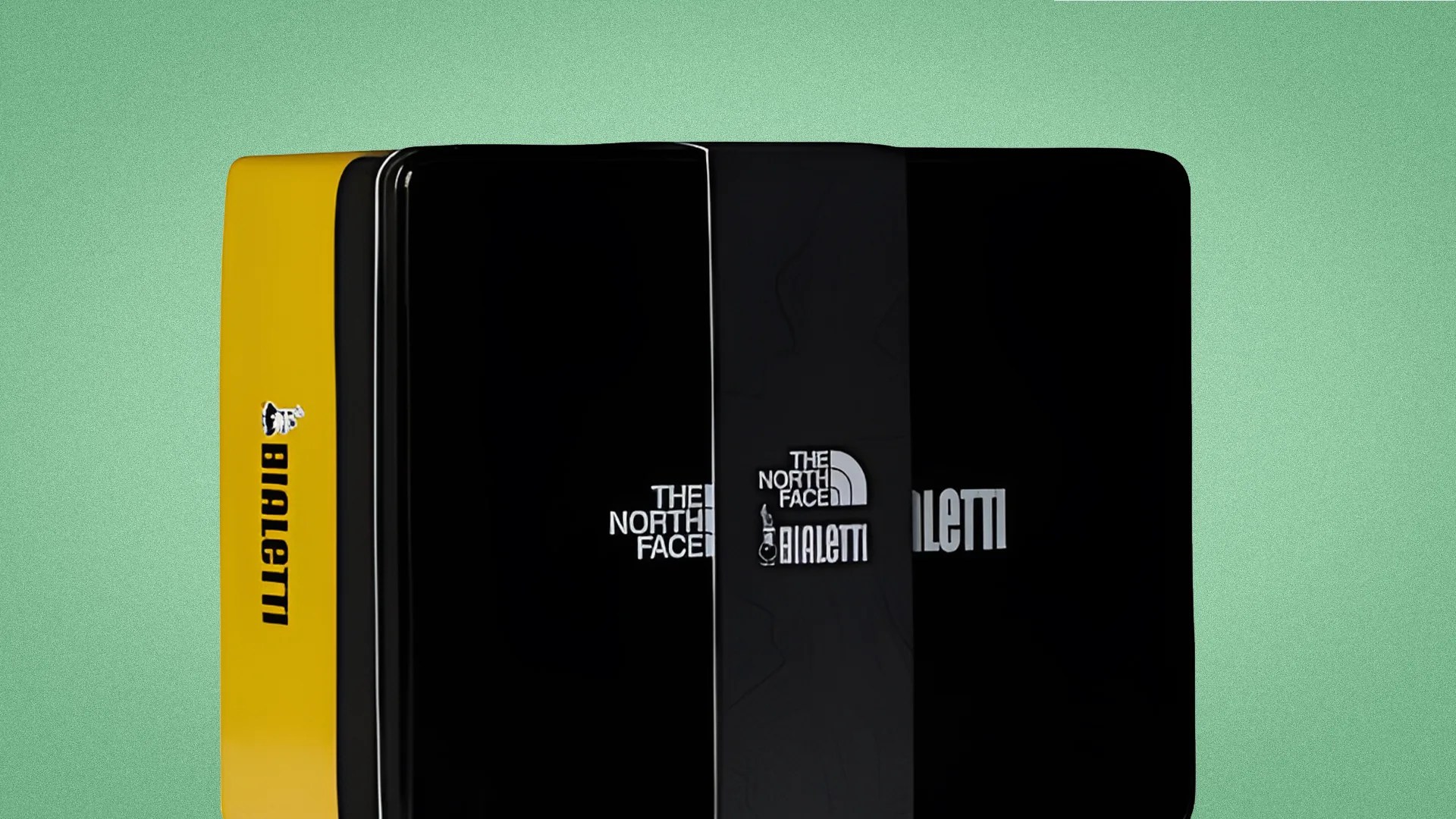 Four stacked rectangular tins with The North Face and Bialetti logos, one tin is yellow and the others are black.