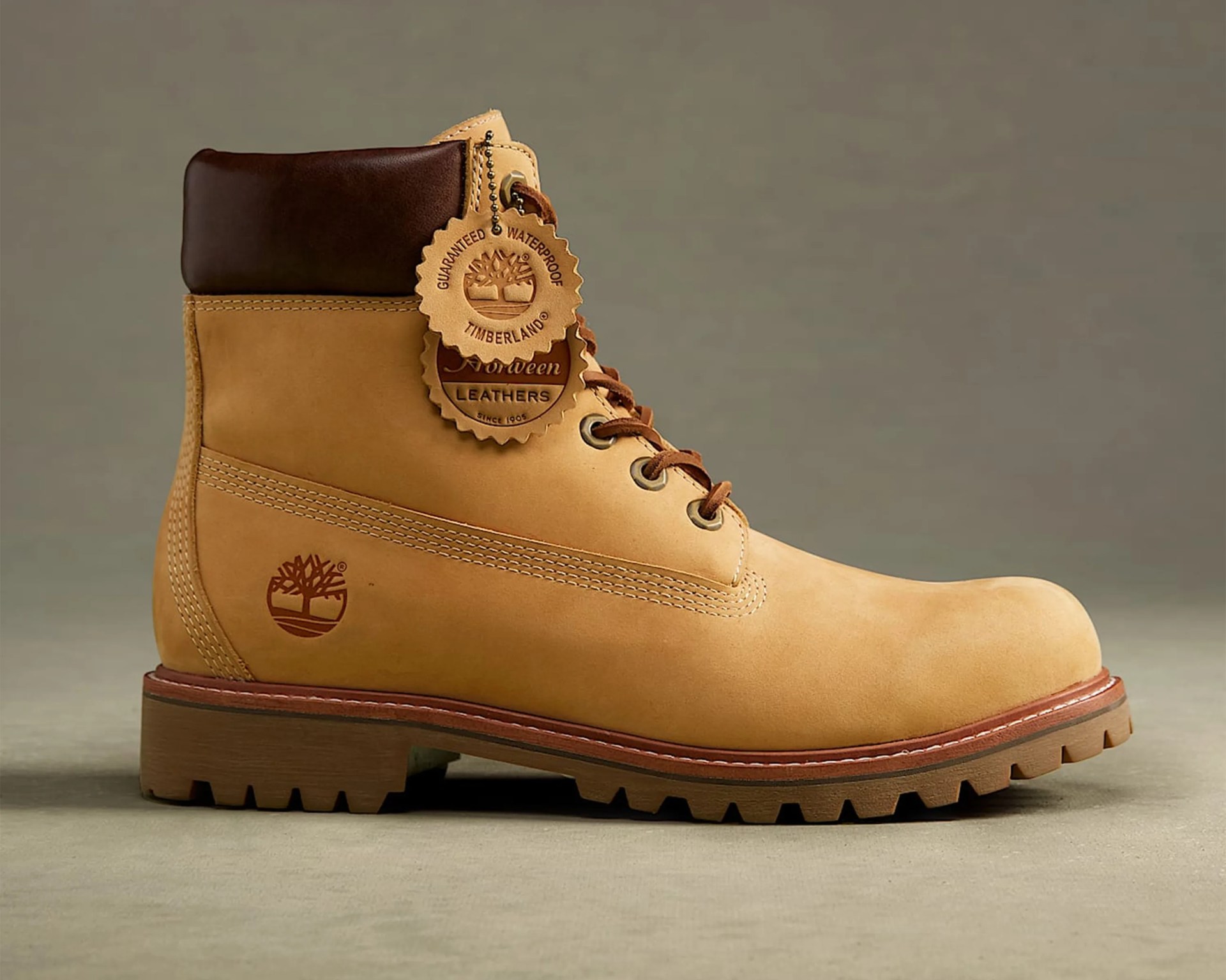 Tan leather Timberland boot with dark brown padded collar and rugged sole on a neutral background.