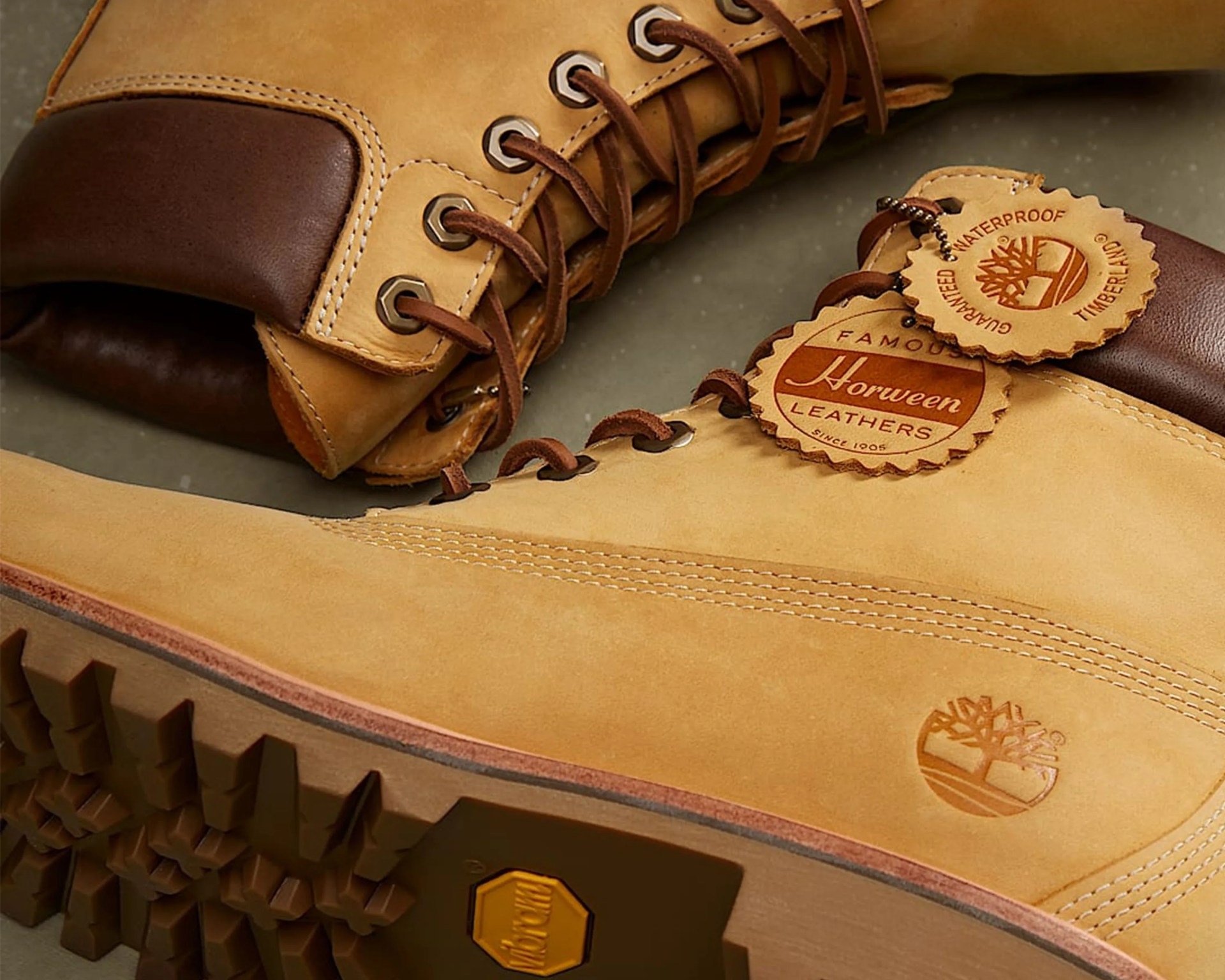 Pair of tan leather Timberland boots with brown padded collars and tags reading "Horween Leathers" and "Guaranteed Waterproof Timberland.