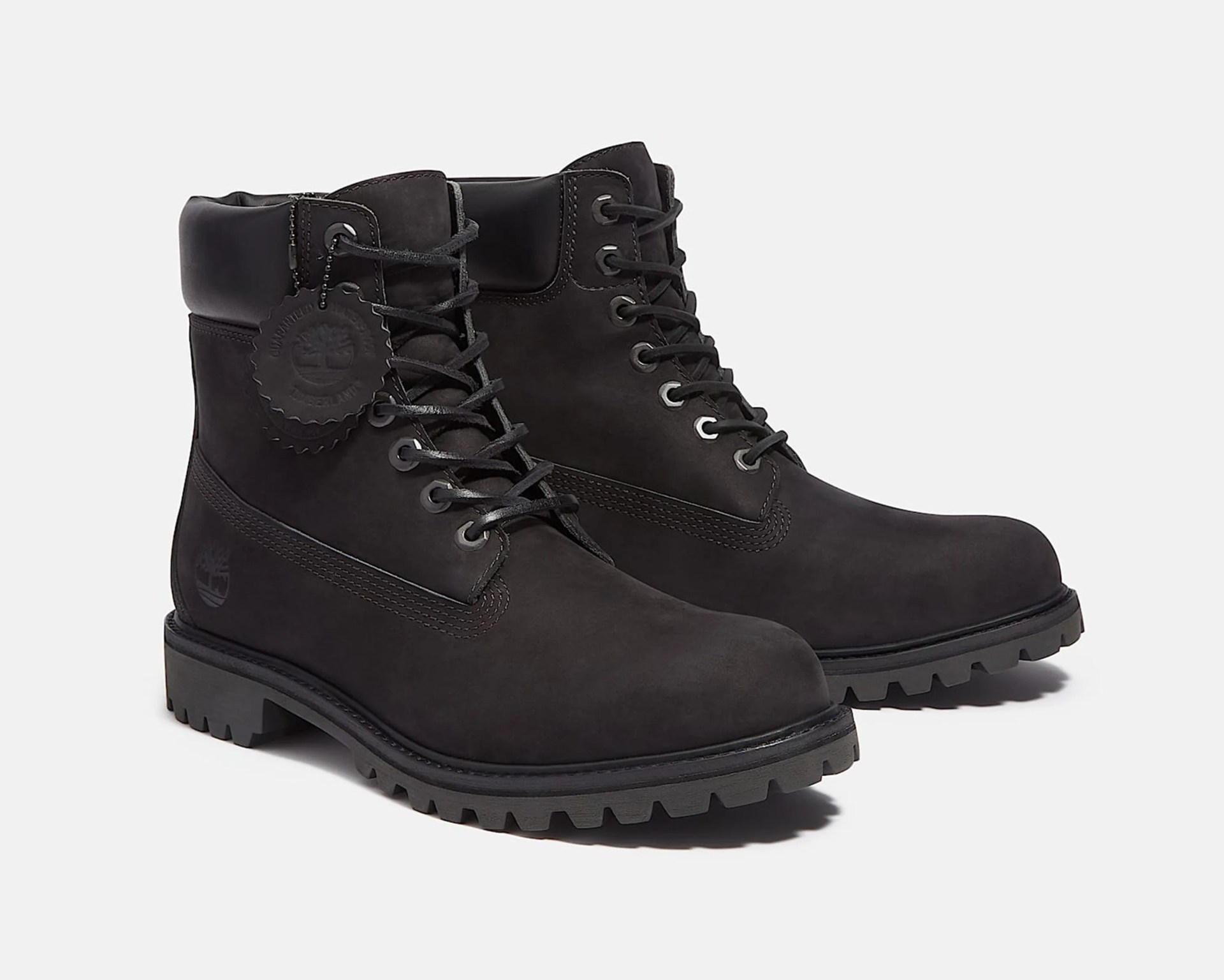 Pair of black leather lace-up boots with padded collars and rugged soles on a white background.