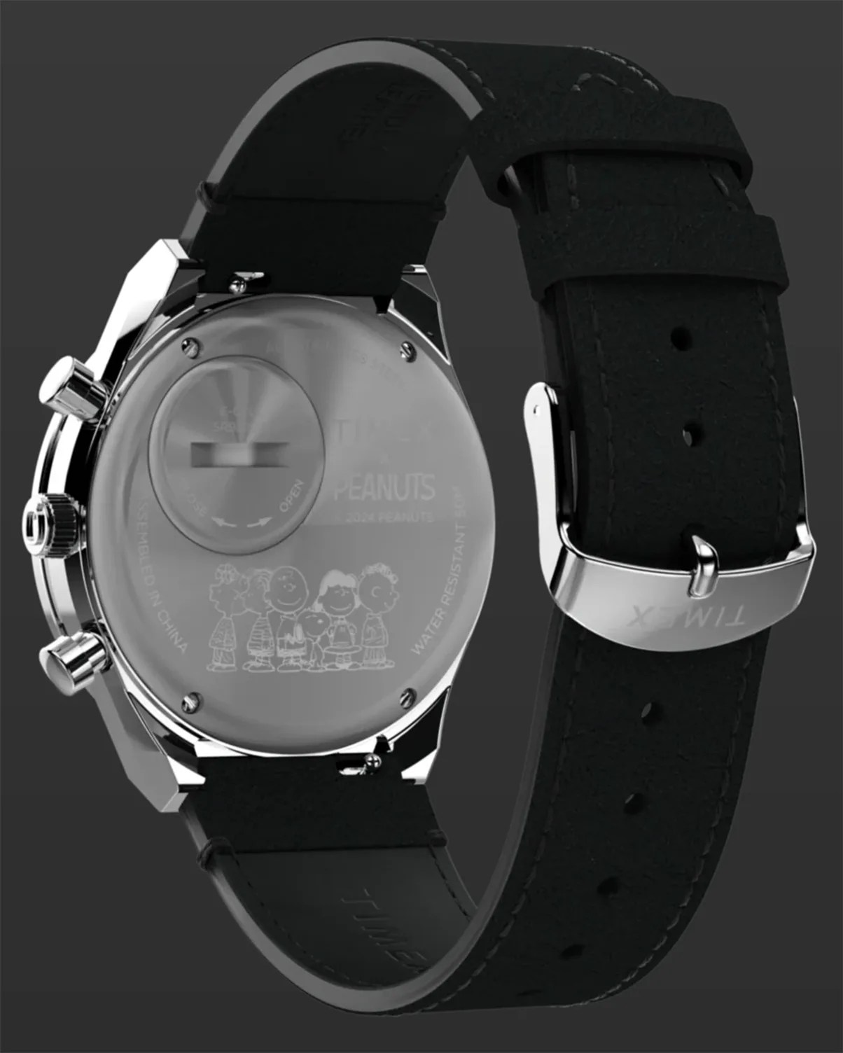 Back view of a Timex watch with black leather strap and engraved Peanuts characters on the silver case back.