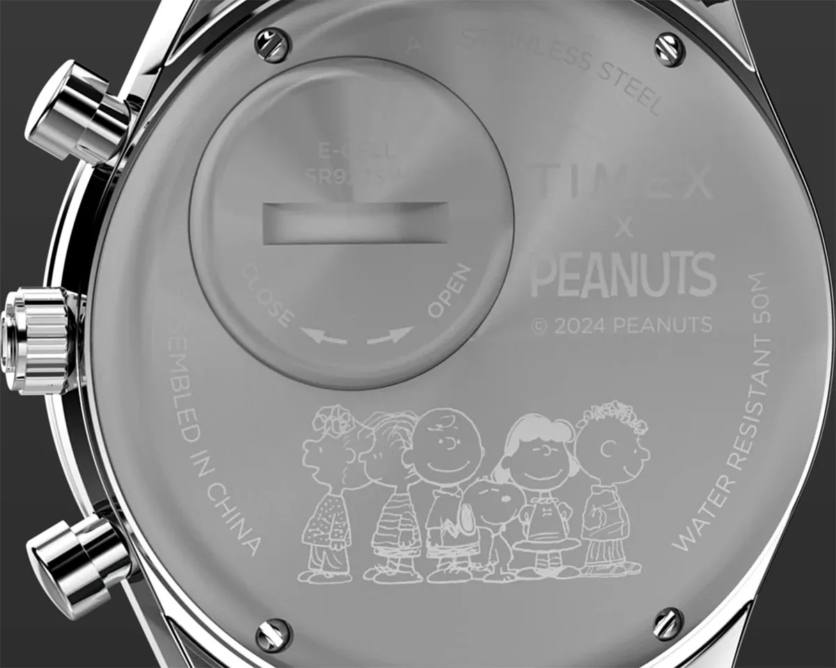 A watch caseback with an etching of Peanuts characters.