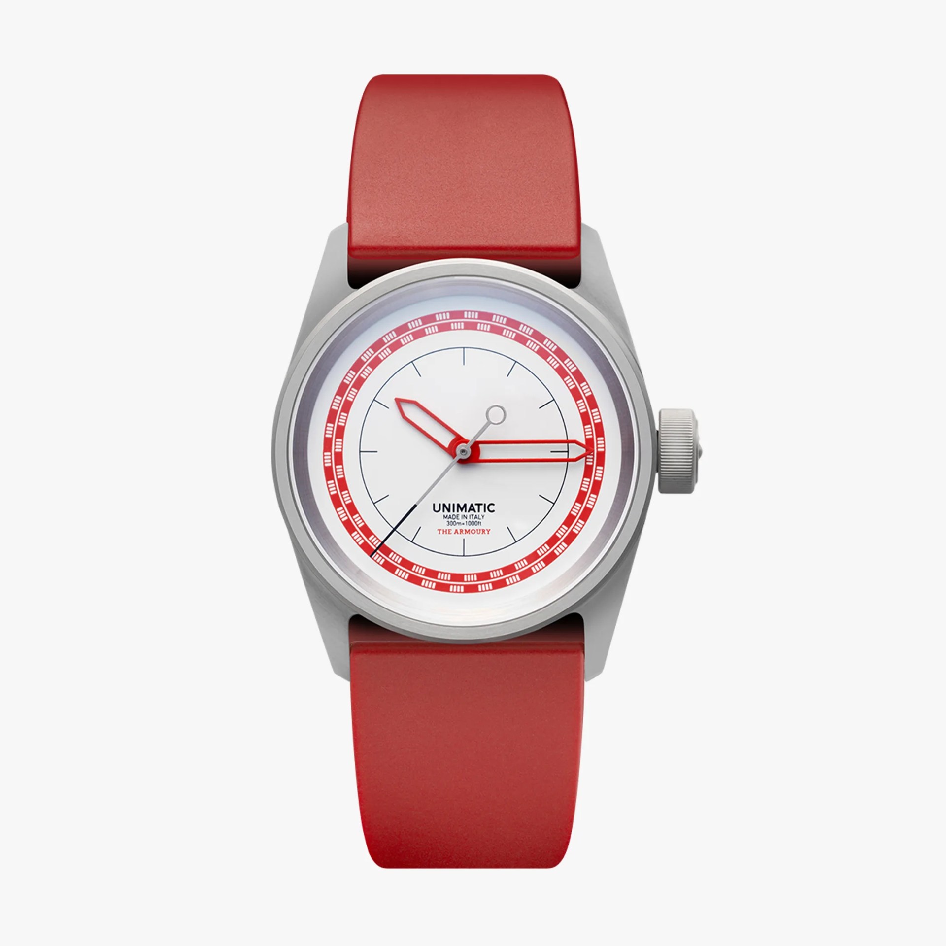 Silver Unimatic wristwatch with white dial, red accents, and red rubber strap.
