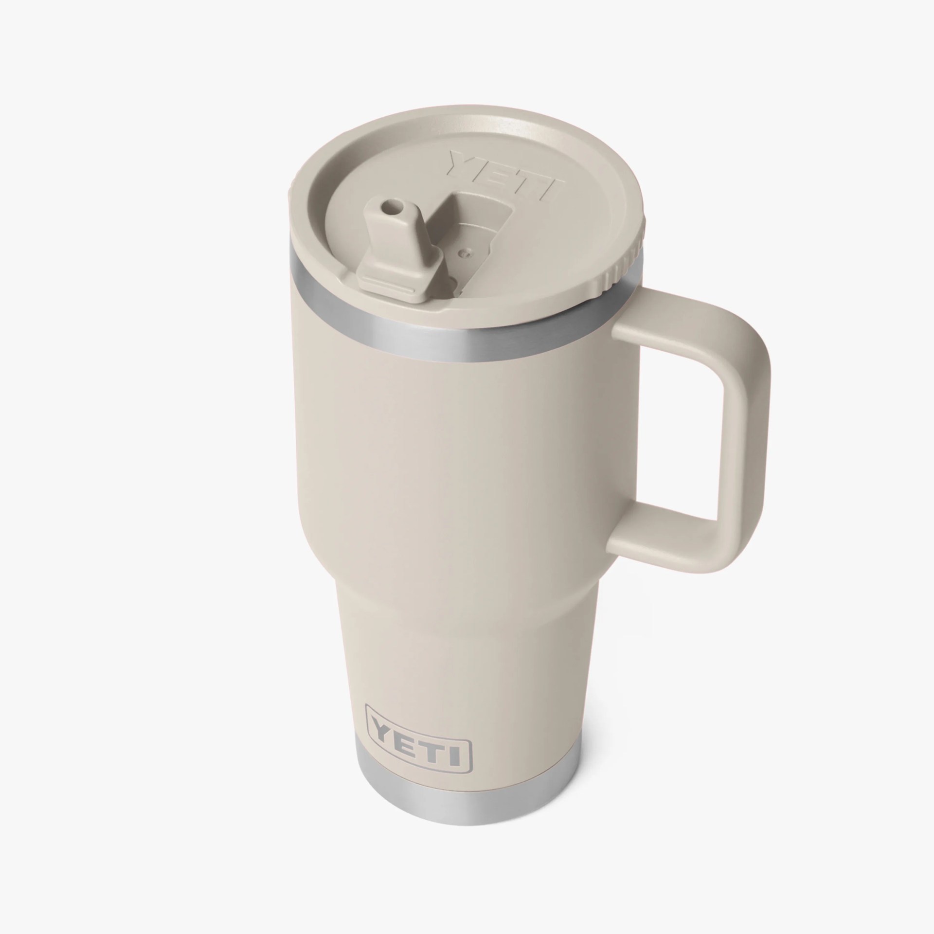 Beige YETI insulated travel mug with handle and spill-resistant lid.