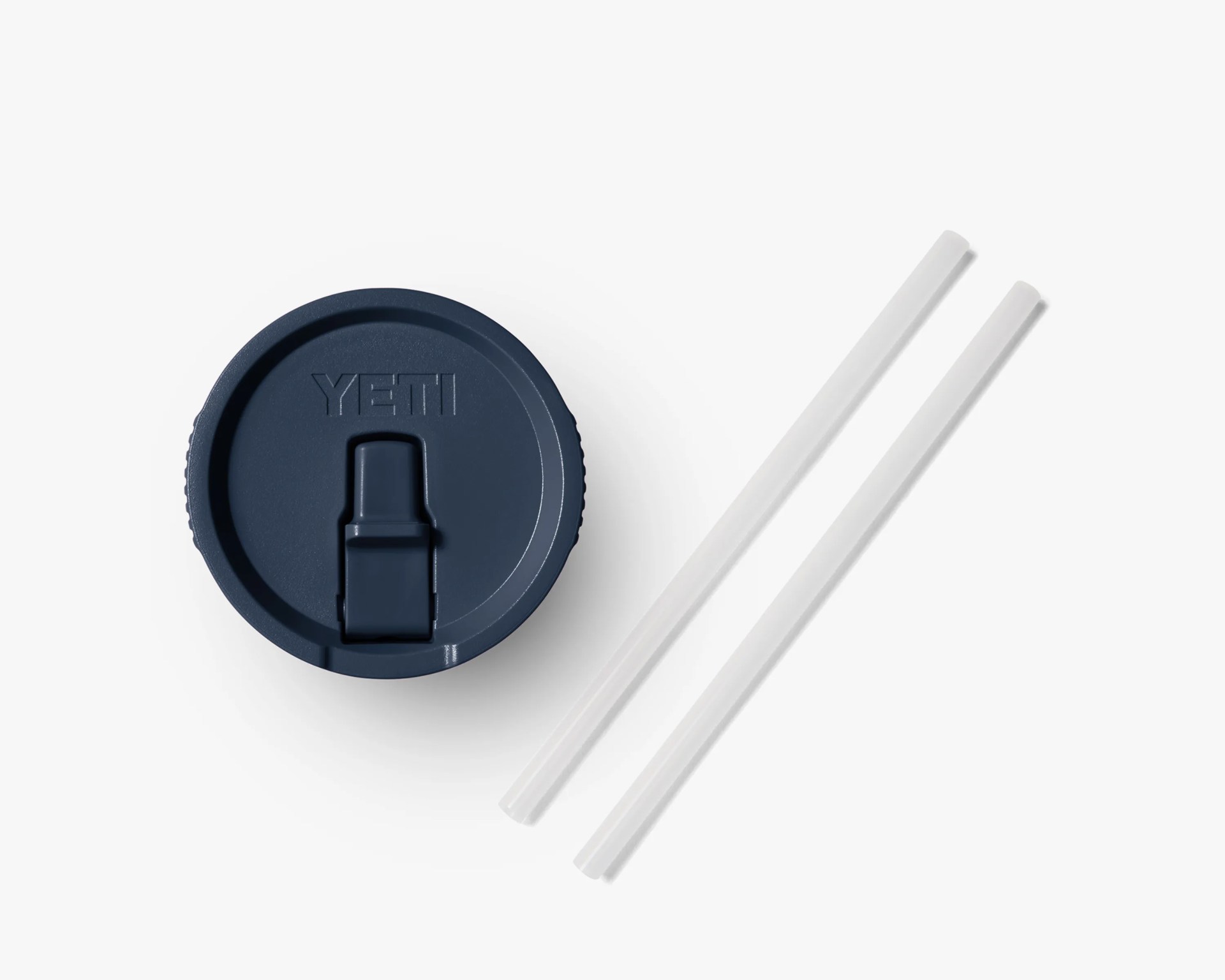 Navy blue YETI tumbler lid with two clear reusable straws on a white background.
