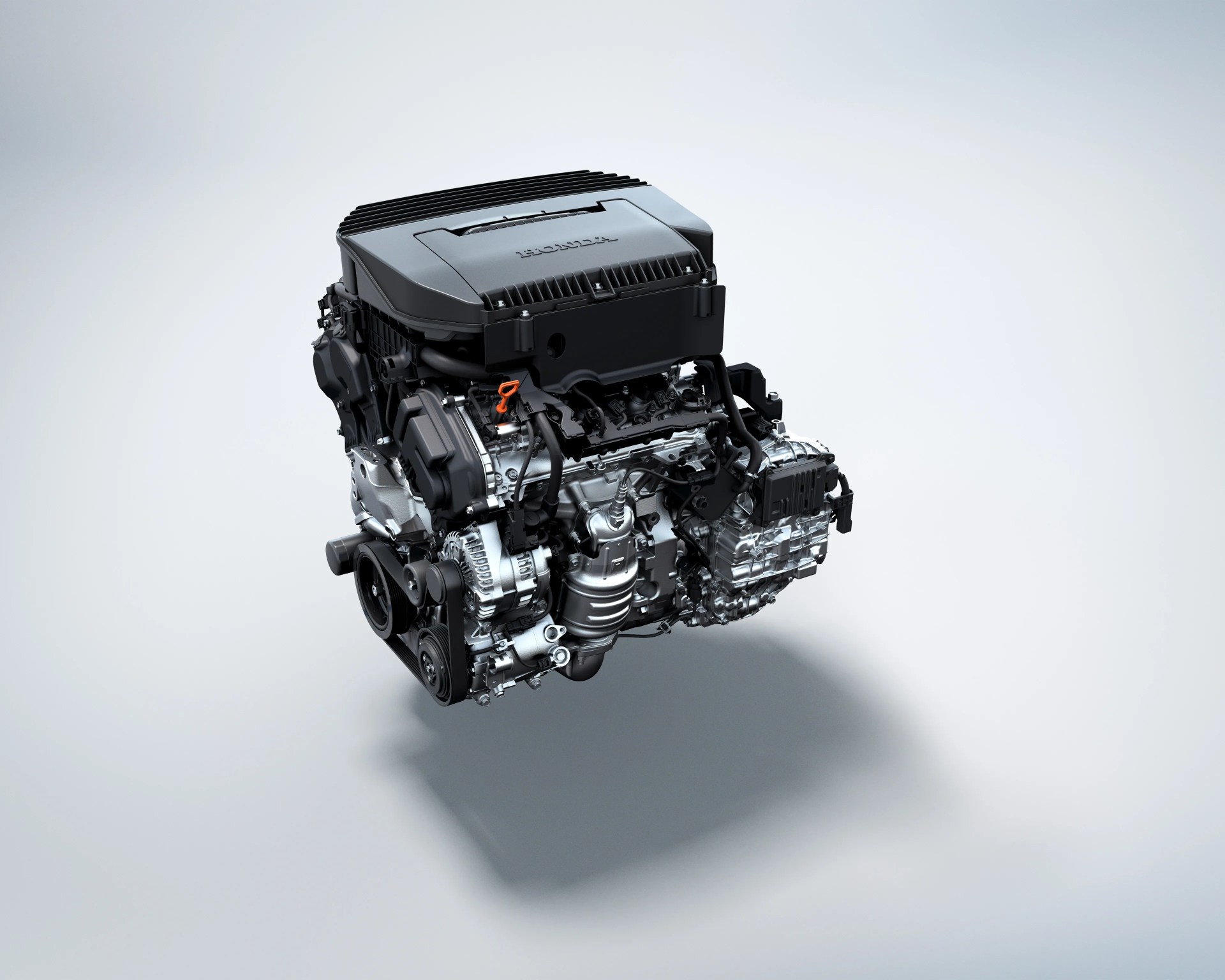 Compact Honda car engine with black and silver components on a light gray background.
