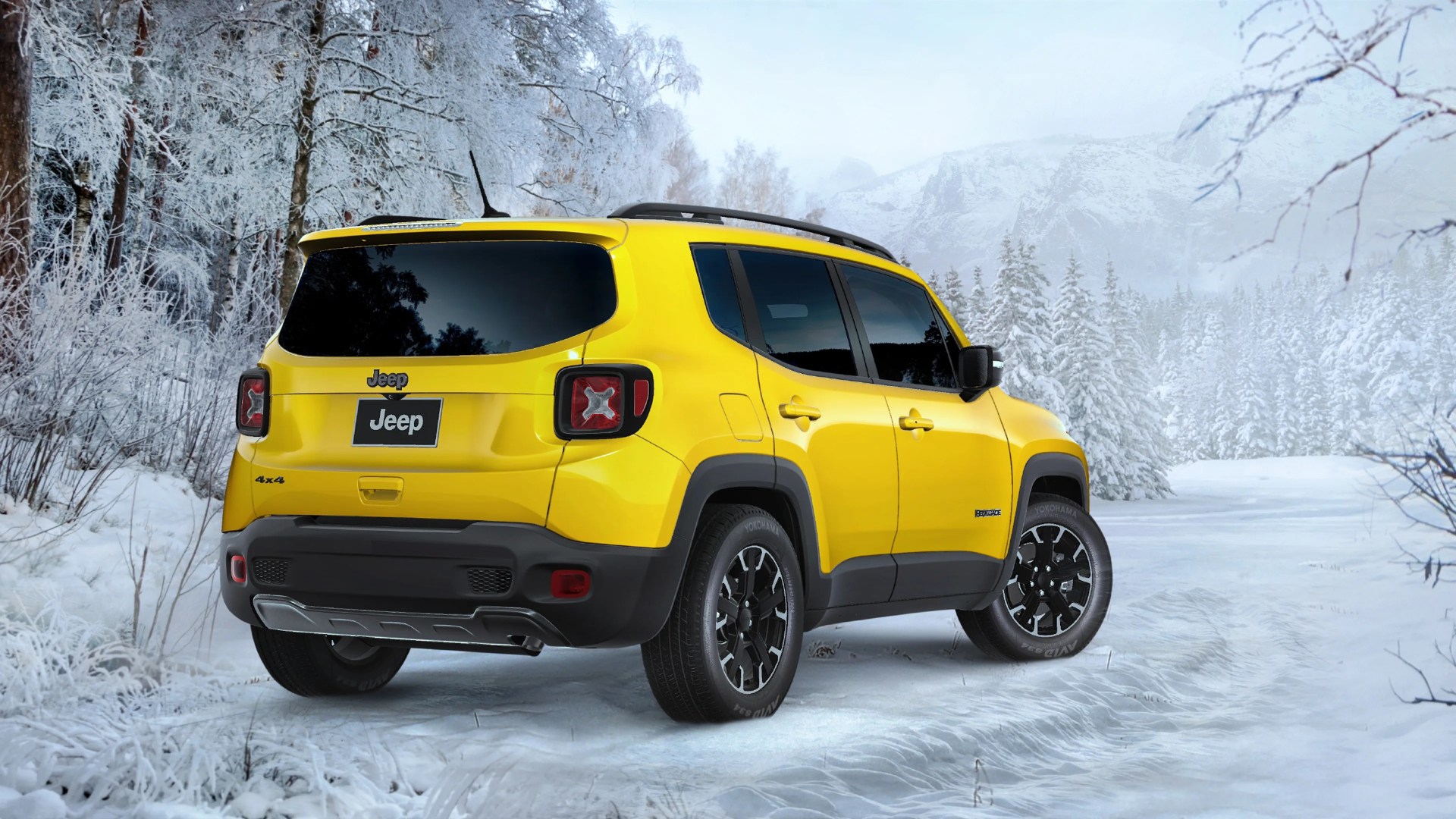 Yellow Jeep Renegade 4x4 SUV parked on a snowy forest road with frosted trees.