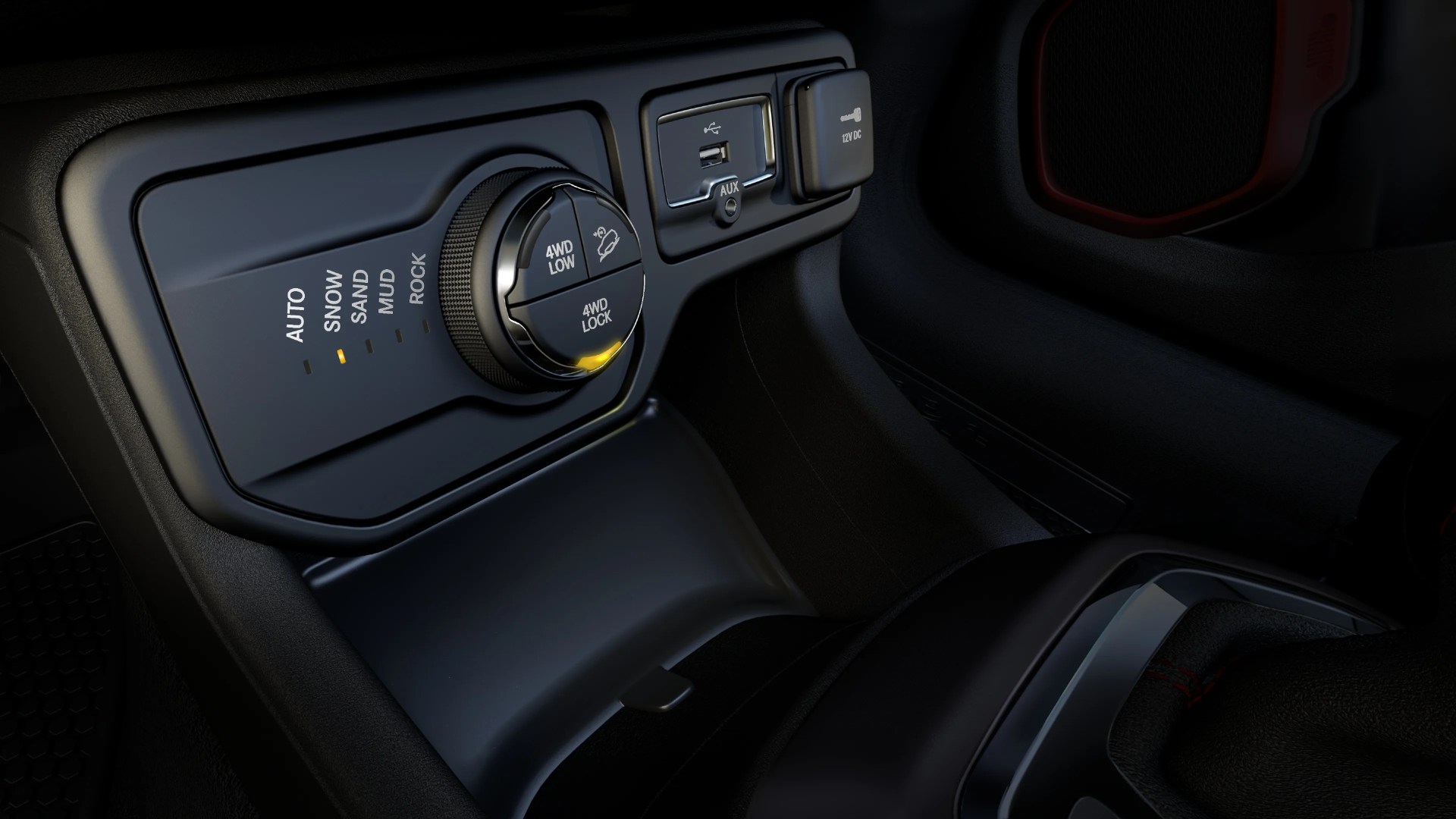 Car terrain control dial with settings for Auto, Snow, Sand, Mud, and Rock, USB port, AUX input, and 12V DC power outlet.