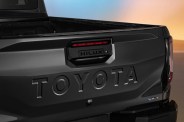 Black Toyota Hilux pickup truck tailgate with embossed TOYOTA lettering and 3.5 EV badge.