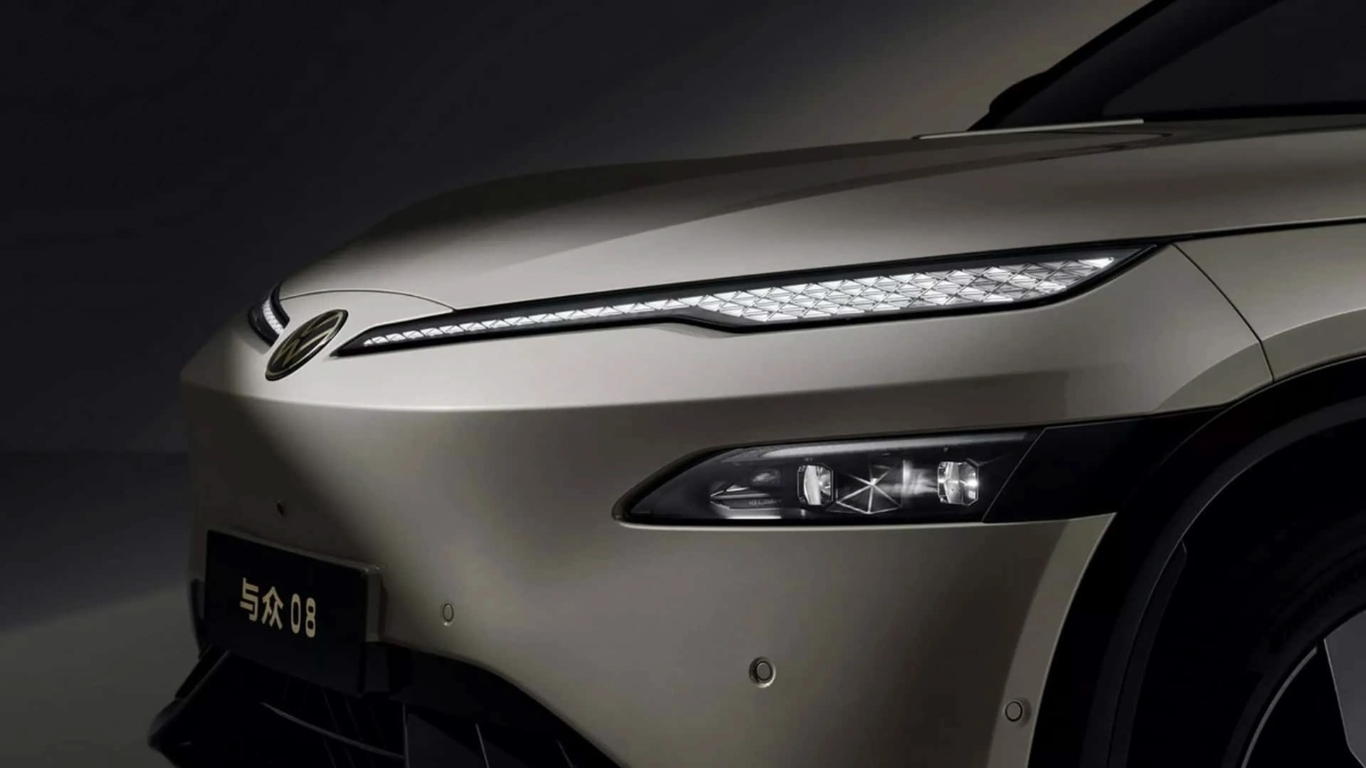 Front close-up of a beige Volkswagen car showing slim LED daytime running lights and main headlights.