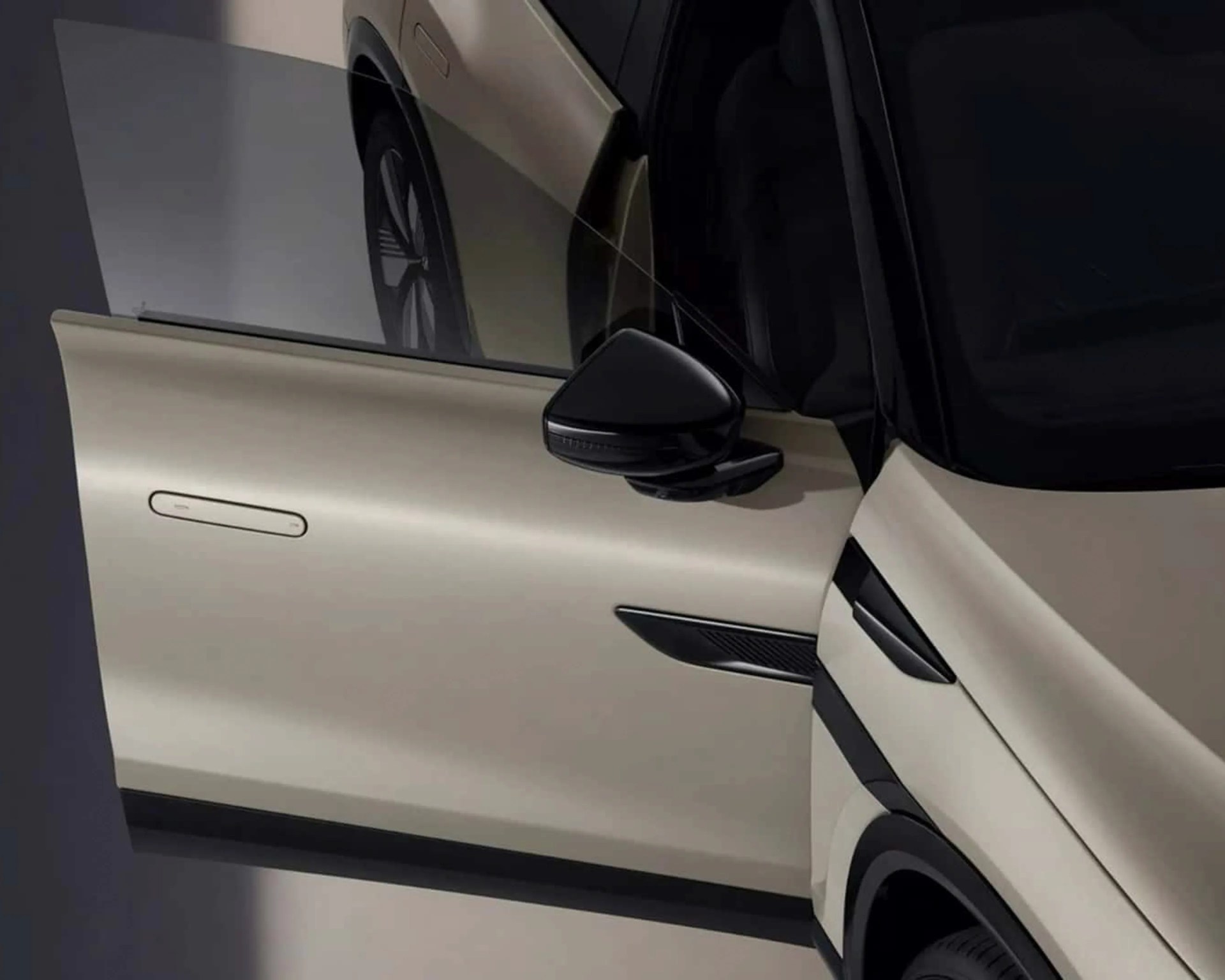 Beige car door open with black side mirror and black trim details.