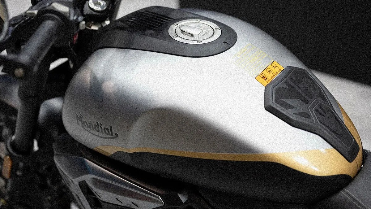 Silver and black motorcycle fuel tank with gold accent and "Mondial" logo on the side.